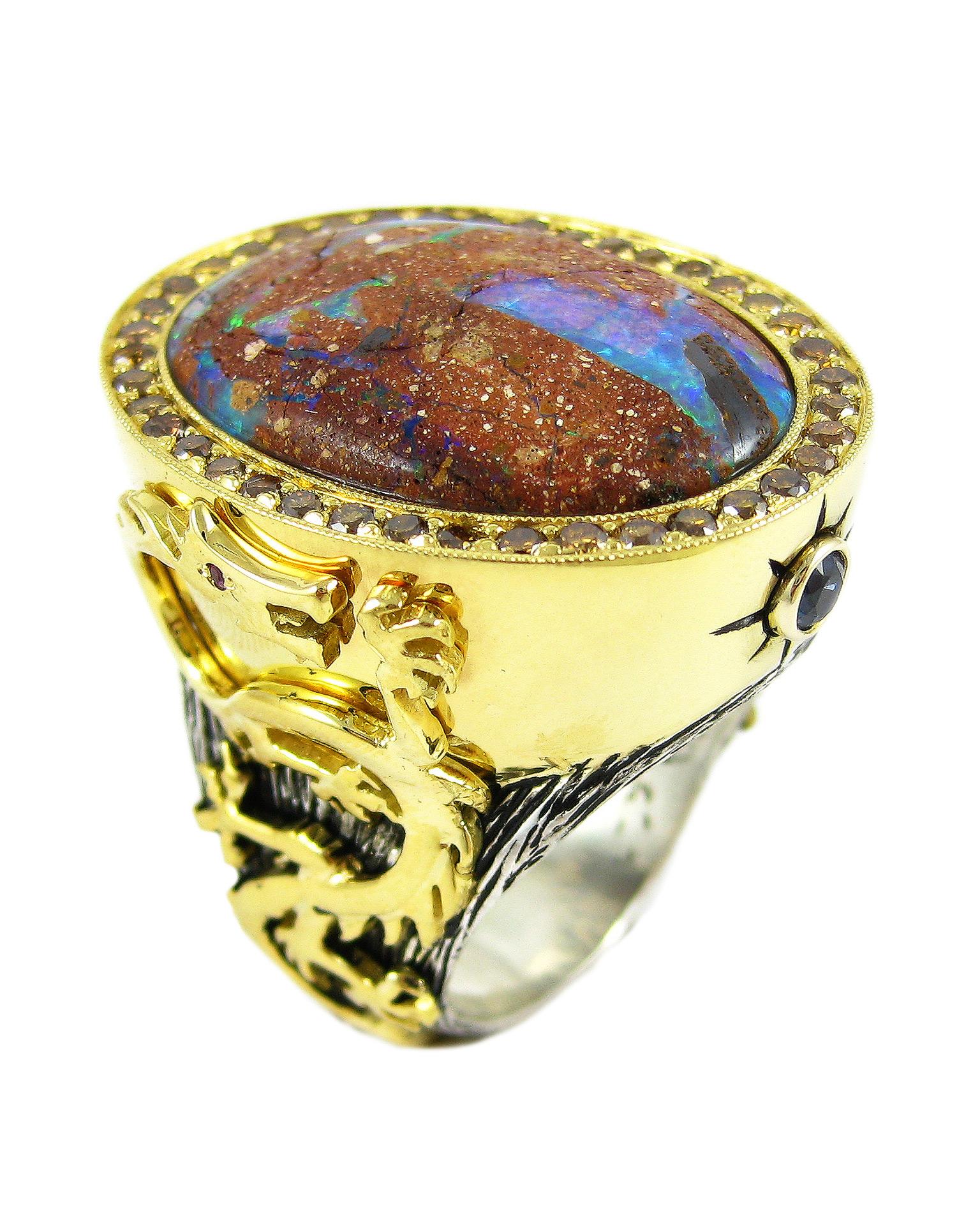 An opal is nature's painting of colors. And this opal ring in sterling silver with 18k yellow gold dragons with ruby eyes—1.03 carat total weight orange diamonds and .34 carat total weight sapphires—endures as wearable art. 

The Objects Organique