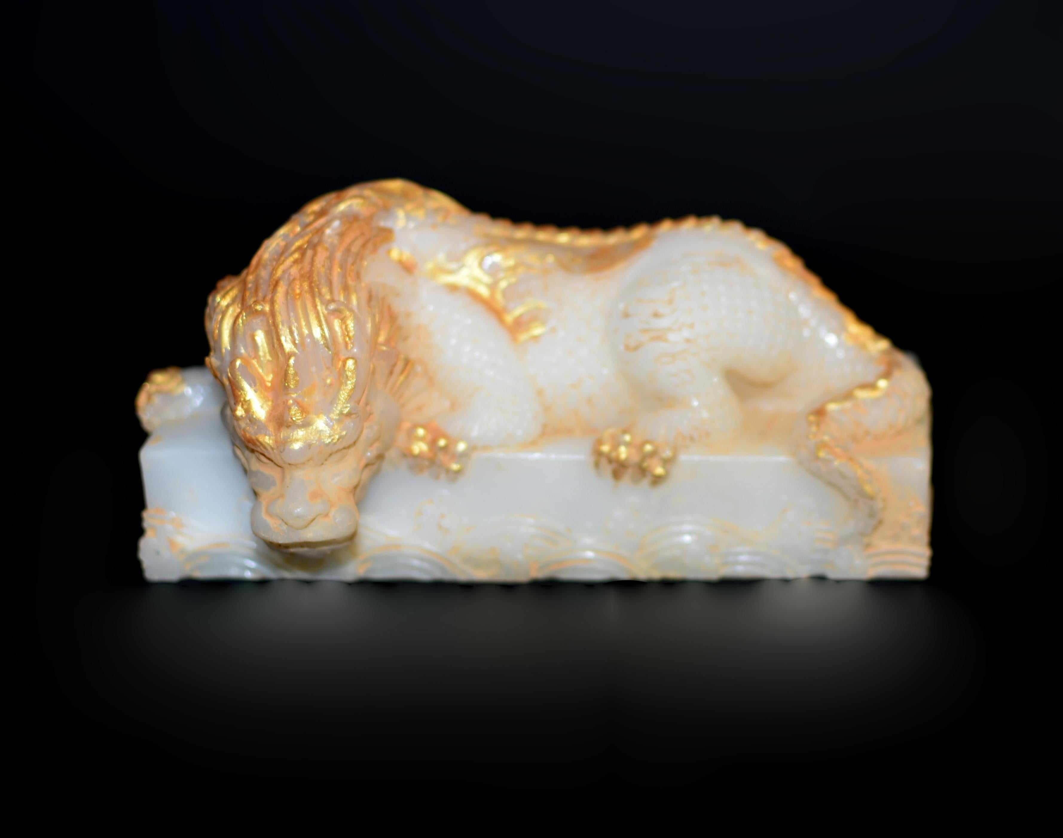 A stunning Italian-made marble composite dragon paperweight, featuring a recumbent dragon poised on an ocean wave. The dragon’s head with pinned-back horns and fierce, bulging eyes, conveying strength and vitality. Its sharp claws grip tightly,