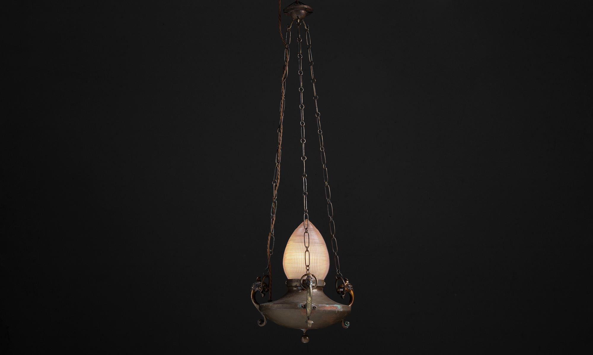 Dragon sanctuary pendant.

England circa 1910

Pendant light with decorative brass dragon supports and prismatic acorn holophane glass shade.

Measures: 10”diameter x 10.75”height x 31.5”height (overall).
 