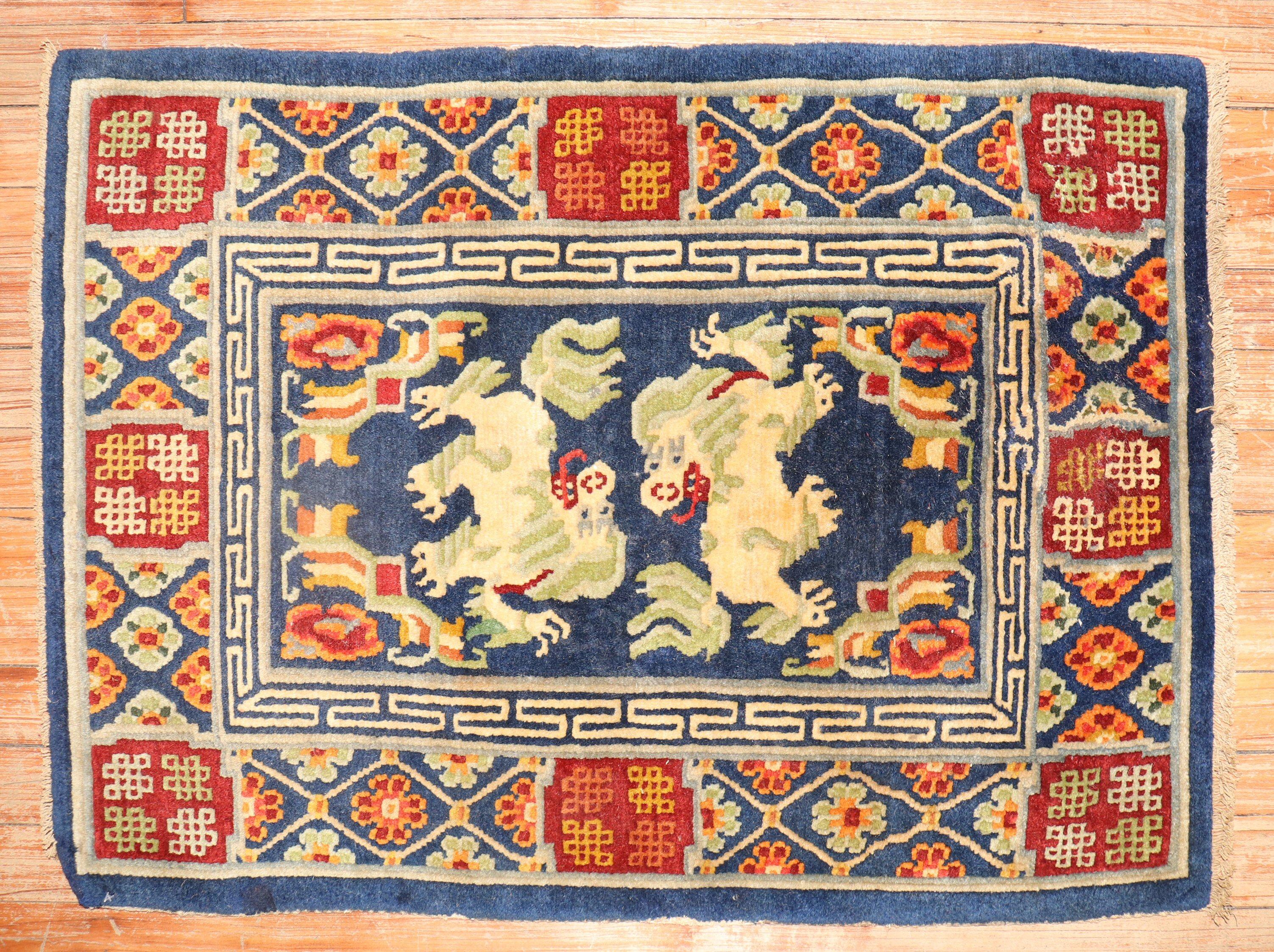 A 3rd quarter of the 20th century Tibetan rug with a dragon motif on a navy field

Size: 2'1'' x 2'11''.

.