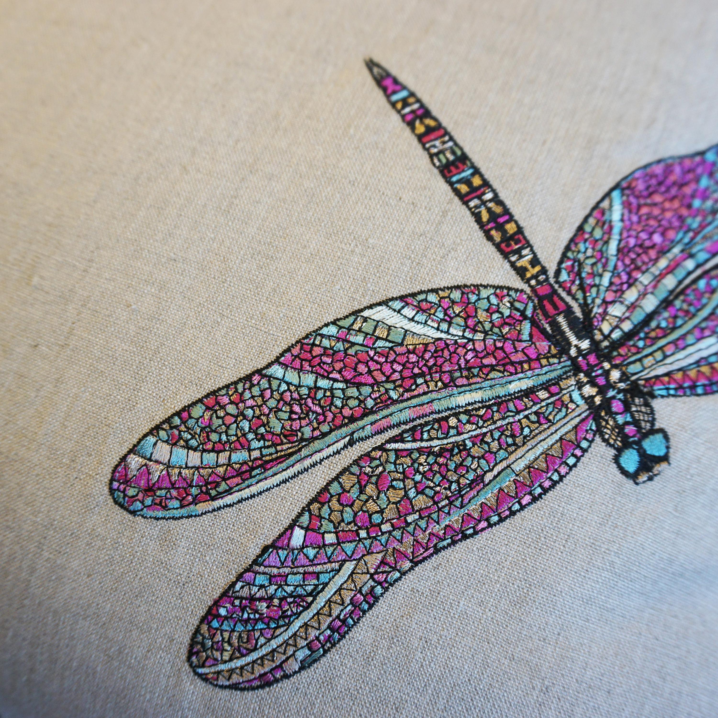 Our Dancing Dragonfly pillows are one of a kind. The pillows are made with a stunning embroidered linen print of multicolored dragonflies. The back it sewn in a distressed textured fabric and is bordered with a pink piping accent.