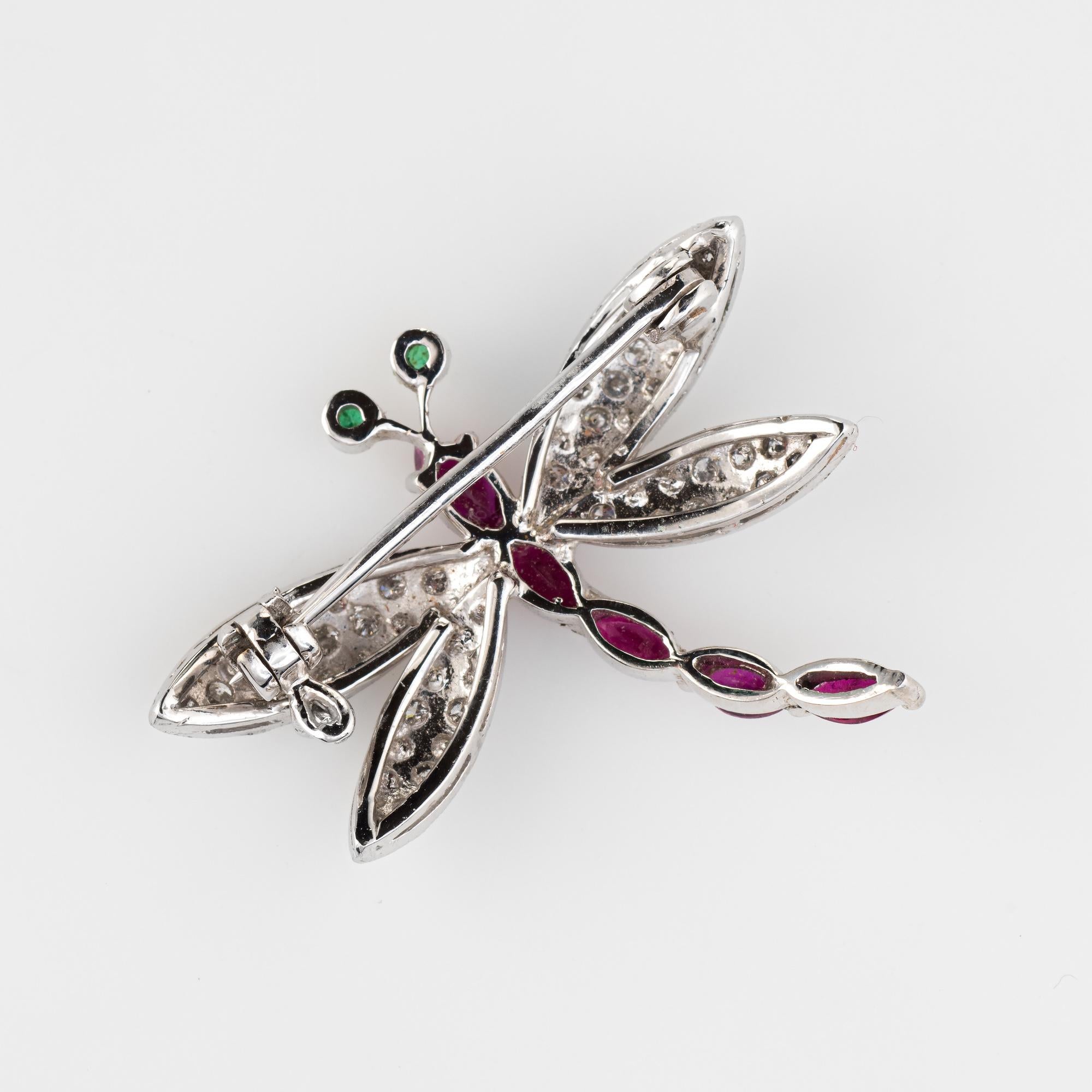 Finely detailed gemstone dragonfly brooch crafted in 18 karat white gold.  

Diamonds total an estimated 0.57 carats (estimated at H-I color and VS2-SI2 clarity). Five marquise cut rubies graduate in size from 0.05 to 0.15 carats. The total ruby
