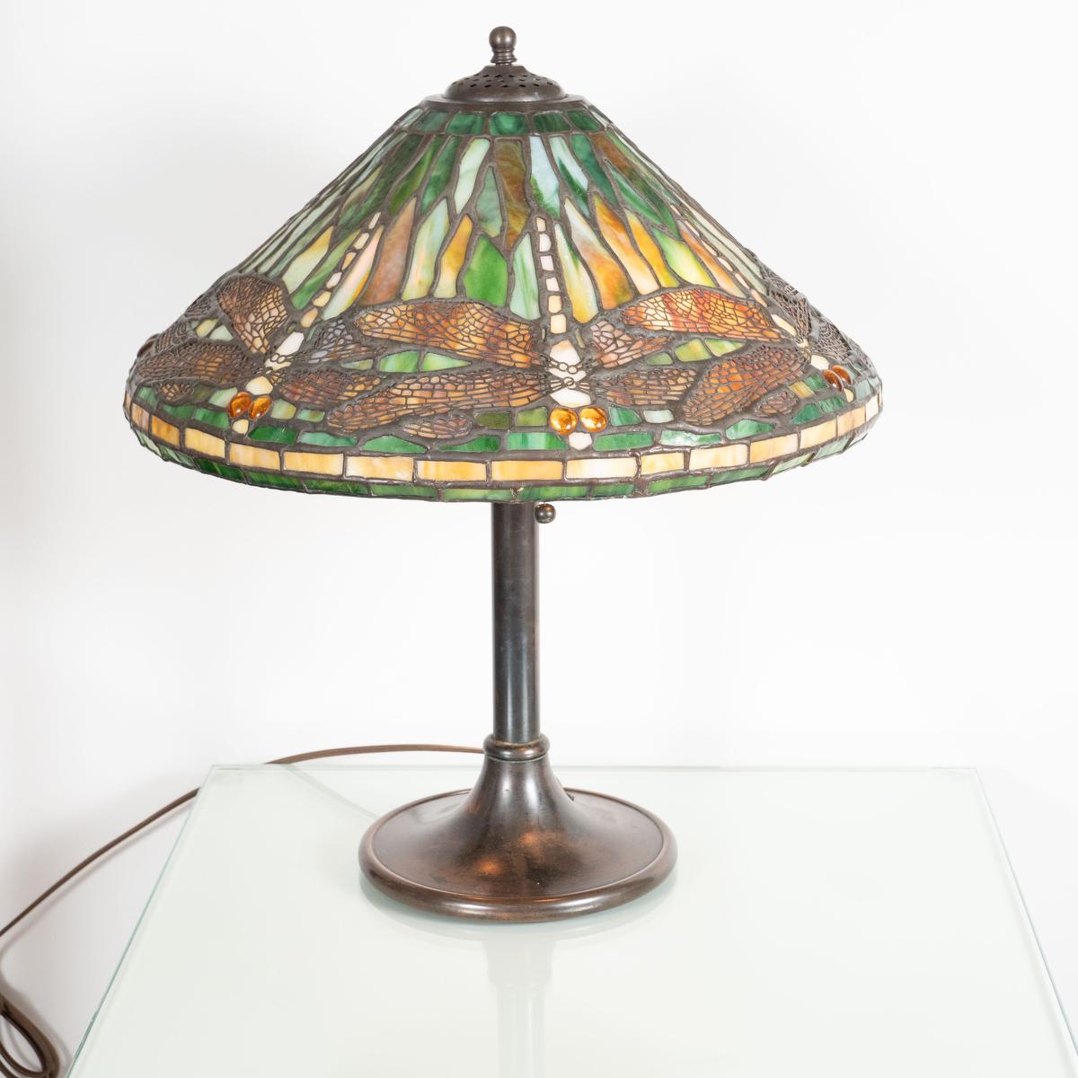 Single table lamp with inlaid glass and openwork metal shade in the style of Lalique.