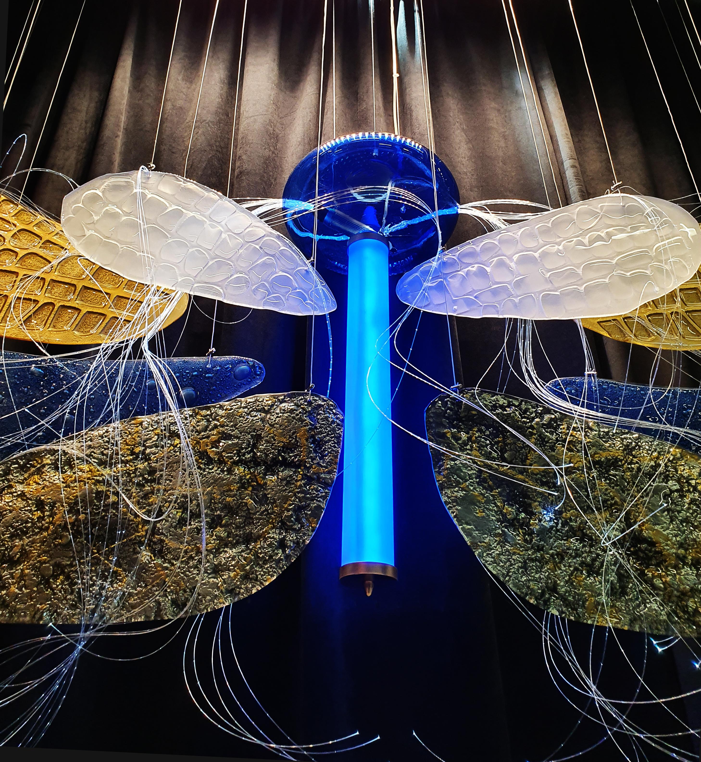 A sculpture, an art installation on a wall, or a lamp combine many elements of art. Inspired by real dragonfly wings, this work of art was shown for the first time in 2019 at the Hotel Show Dubai, which attracted crowds of visitors. The second