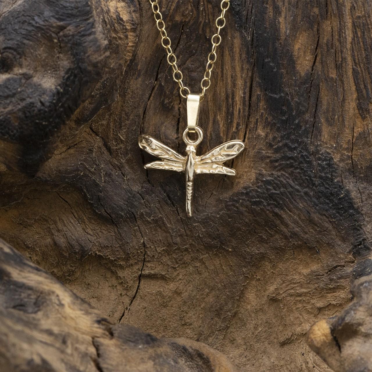 An artistic dragonfly pendant made from solid 9K Gold with a Solidd 9K Gold 18