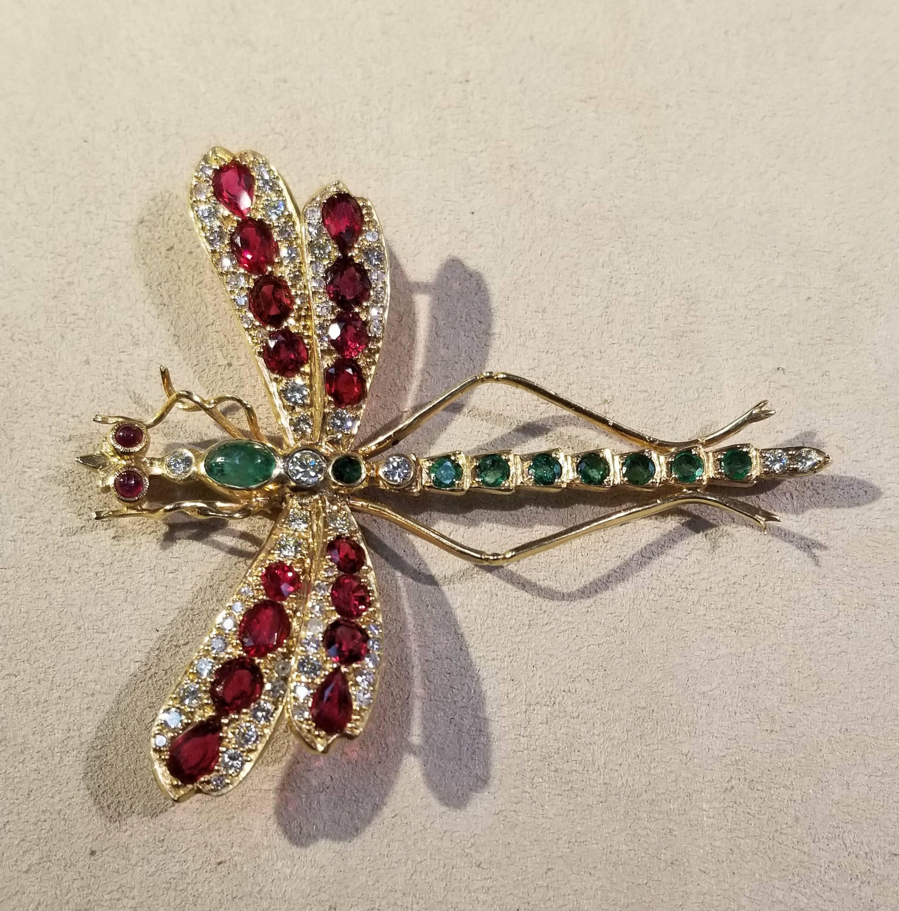 Dragonfly Pin, 14k Yellow Gold.
The pin has diamonds, rubies, and emeralds.
Diamonds: FGH in color, SI in clarity, and 2.08 cts. 
Rubies: SI in clarity and 4.21 cts.
Emeralds: SI-I in clarity and 1.65 cts.