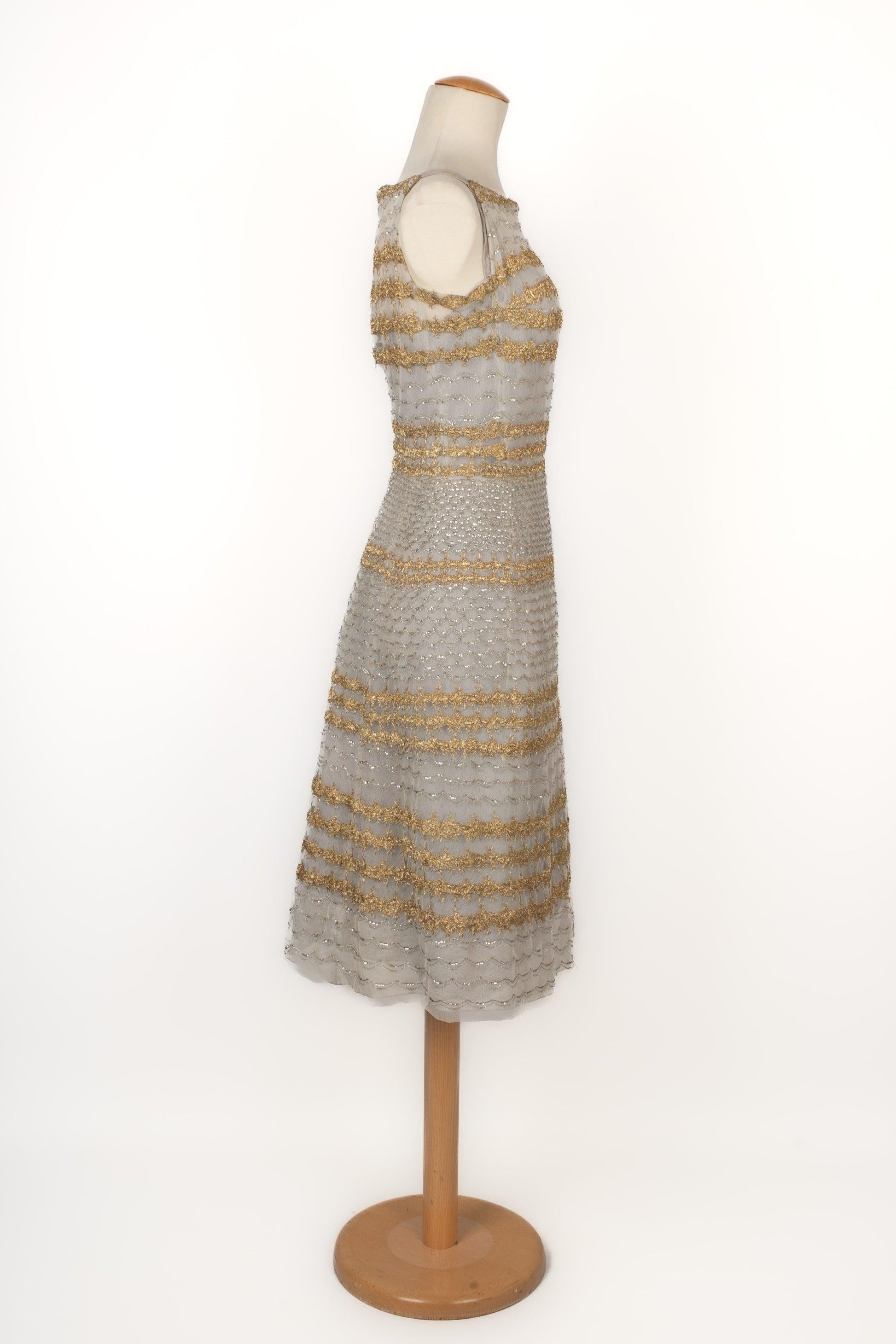Dragoni Venezia - Vintage tulle dress embroidered with pearls, sequins, and golden lamé. No size indicated, it fits a 34FR/36FR. 1950 Haute Couture Collection. Italian Designer.

Additional information:
Condition: Very good condition
Dimensions: