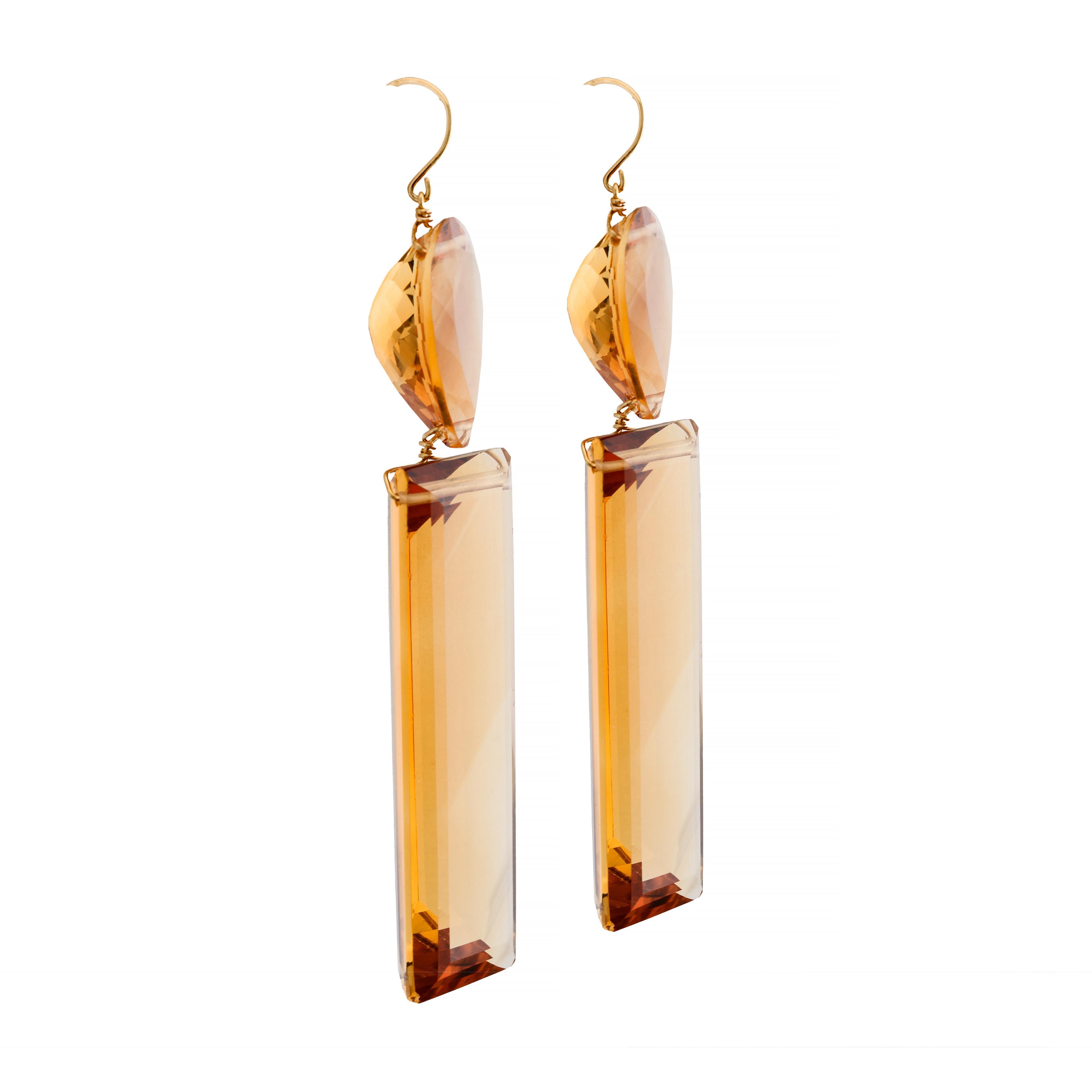 Aston Estate Jewelry Presents:

A striking and substantial pair of modern dangle earrings. Featuring a bold design with an emerald-cut citrine of 55 carats as the focal point. Topped with a pear-cut citrine, both stones exhibit a vibrant orange hue.