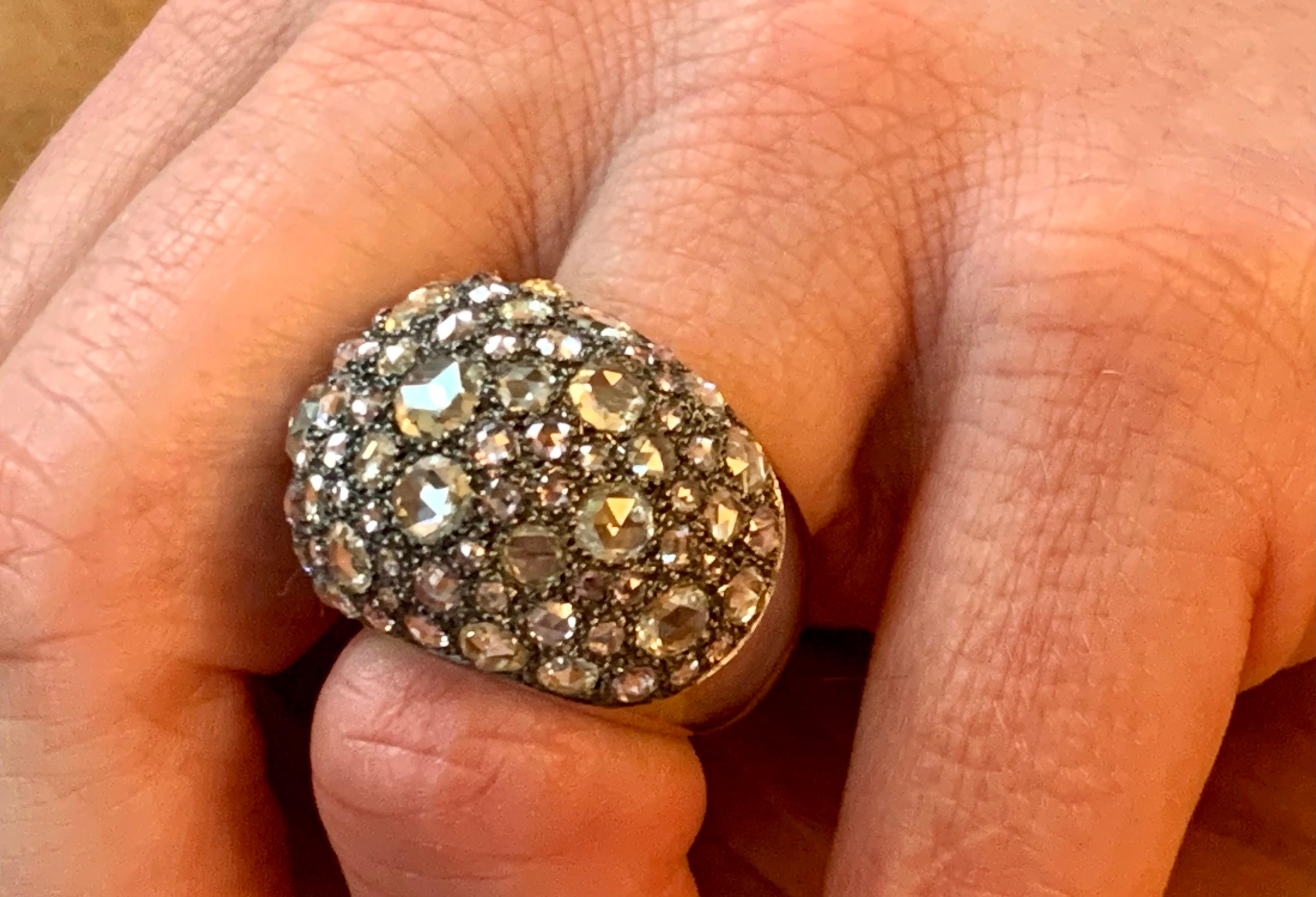 One of a kind olid 18 K white Gold Ring with black Rhodium to creaate a dramatic and mystical look!  Pavé set with pastel colored Rose cut Diamonds totalling 10.45 ct. 
The ring is currnently size 54/14 (american Ring size 7) but can easily be