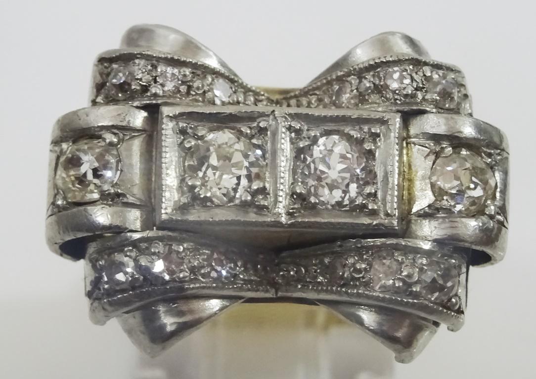A unique tank ring with a very substantial look,
It is made in acid tested 18 karat white and yellow gold and is set with old European Cut Diamonds,
the two central stones are 5 mm , none of the old cut stones are exactly any shape so i am sizing