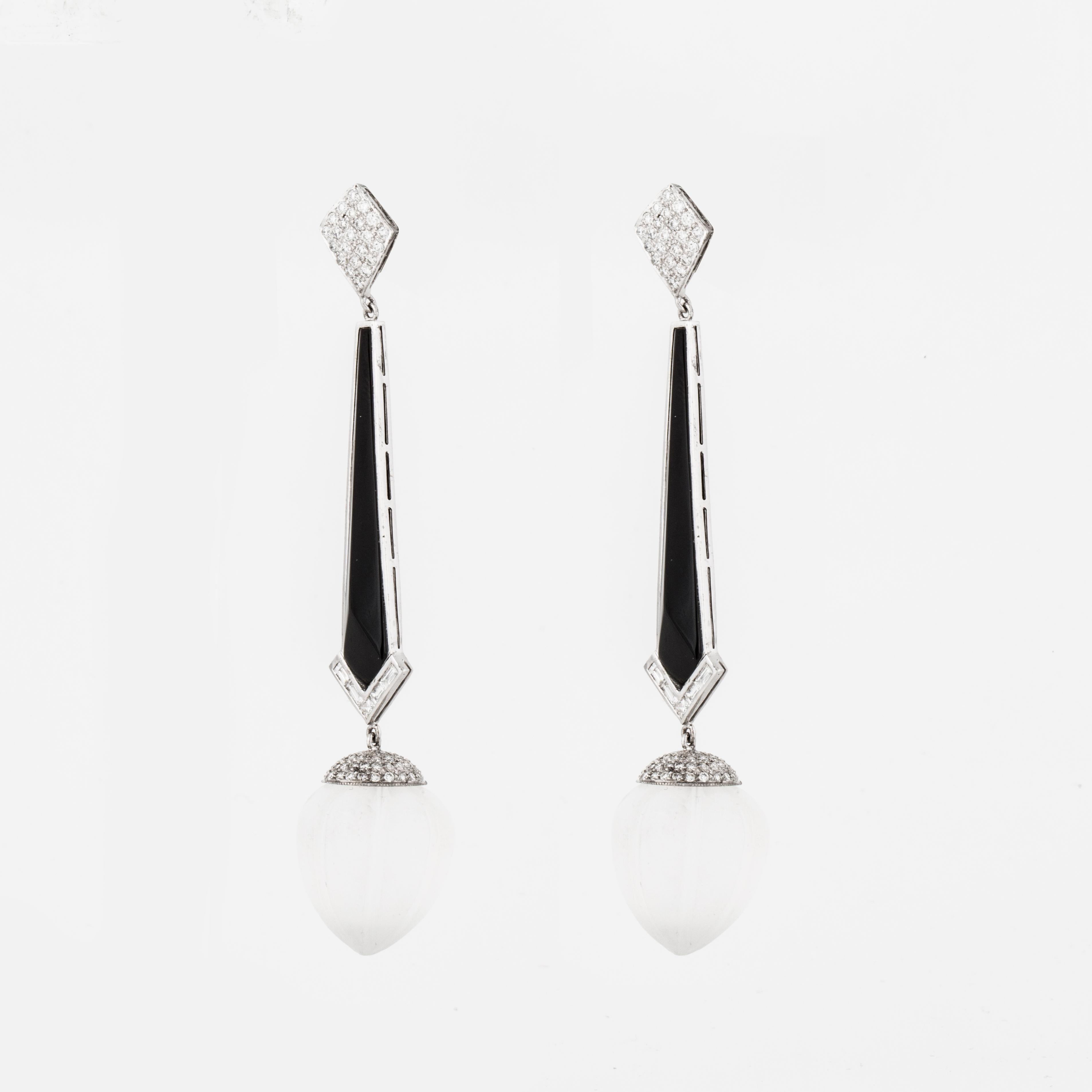 Dangle drop earrings composed of 18K white gold, rock crystal spheres, carved onyx, and round diamonds.  There are a total of 174 round diamonds that total 2.55 carats; G-H color and SI-SI1 clarity.  These earrings measure 3 1/2 inches long and 3/4