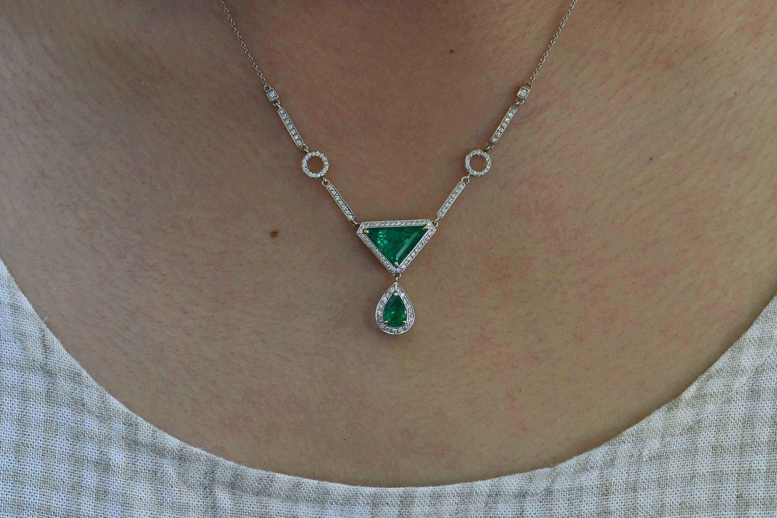 The Buckeye Vintage Necklace. A simple, yet simply breathtaking Art Deco style drop necklace. This vibrant, vivid Emerald suite glows with a fire from within. The striking, geometric triangle, teardrop, circles and bars, all framed within diamond