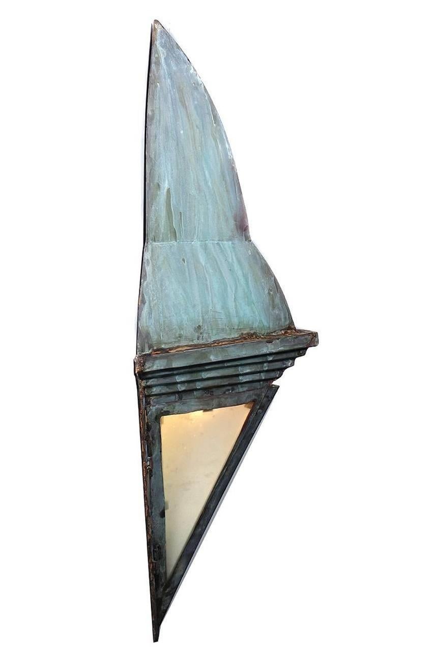 The beautiful wedge shape sconce has a bit of an Arts & Crafts or Frank Lloyd Wright look. The all copper handcrafted sconce is finished in a weathered verdigris green. The two lit panels are milk glass. It's an impressive 36 inch tall lamp and very