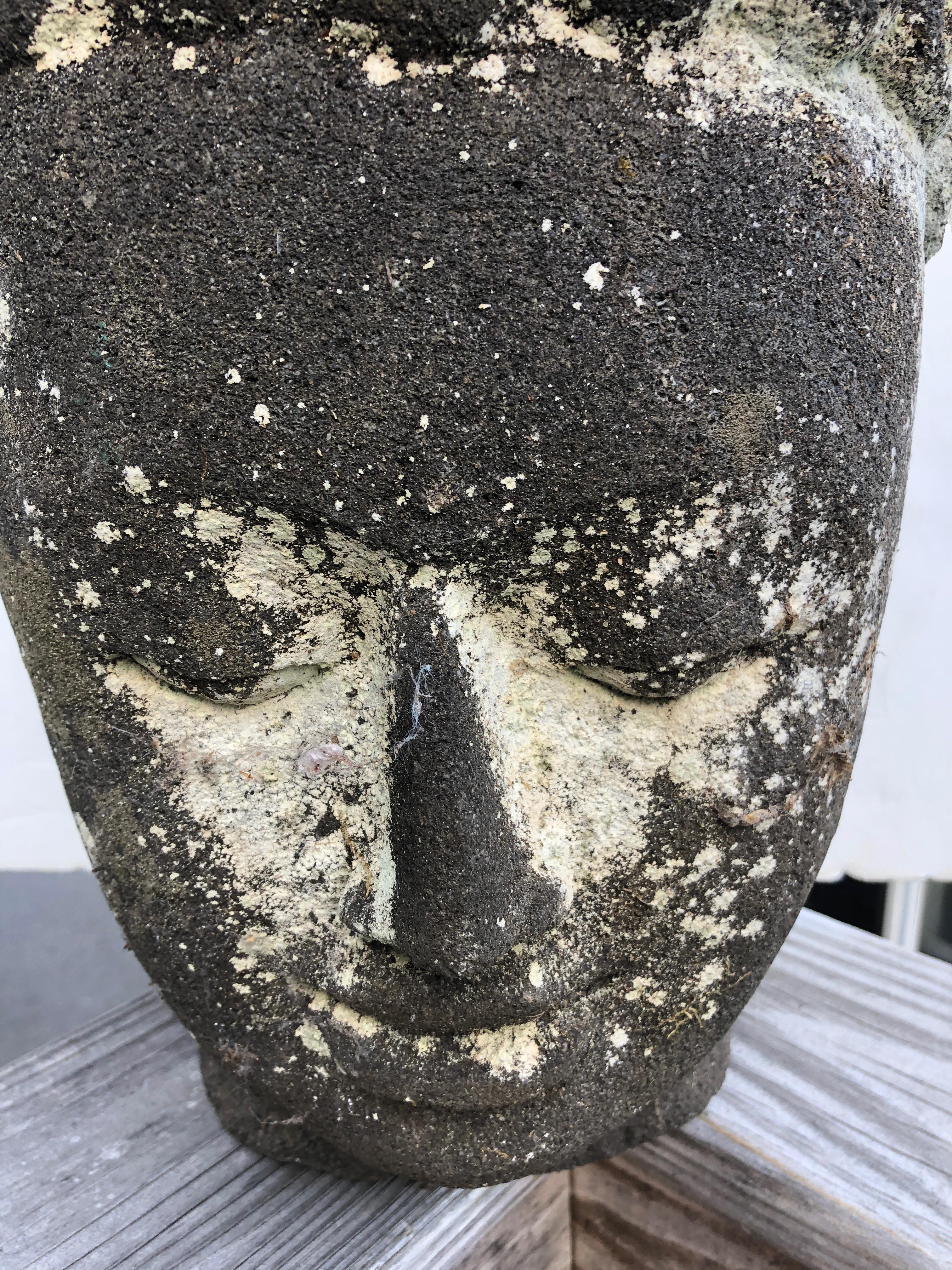 A gorgeous cast stone Buddha head for the garden or patio, large and artfully organically adorned with moss.