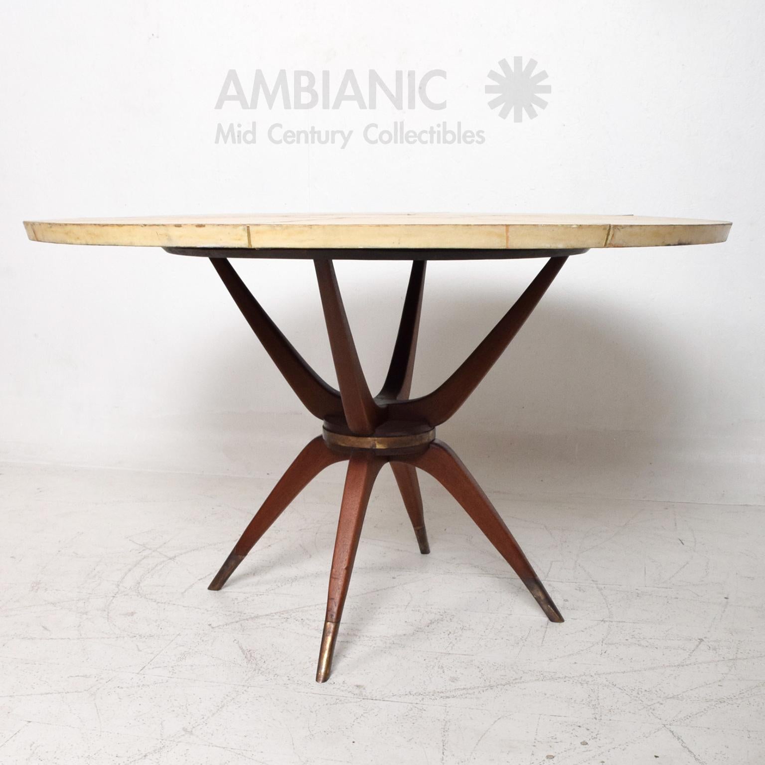 Splendid Round Dining Table in Goatskin, Mahogany & Patinated Brass 
made in Mexico circa 1950s.
Mexican Modernism inspired by Italian design.
Unmarked.
Measures: 28.5 H x 47.38 in diameter.
Original Unrestored vintage condition with vintage patina.