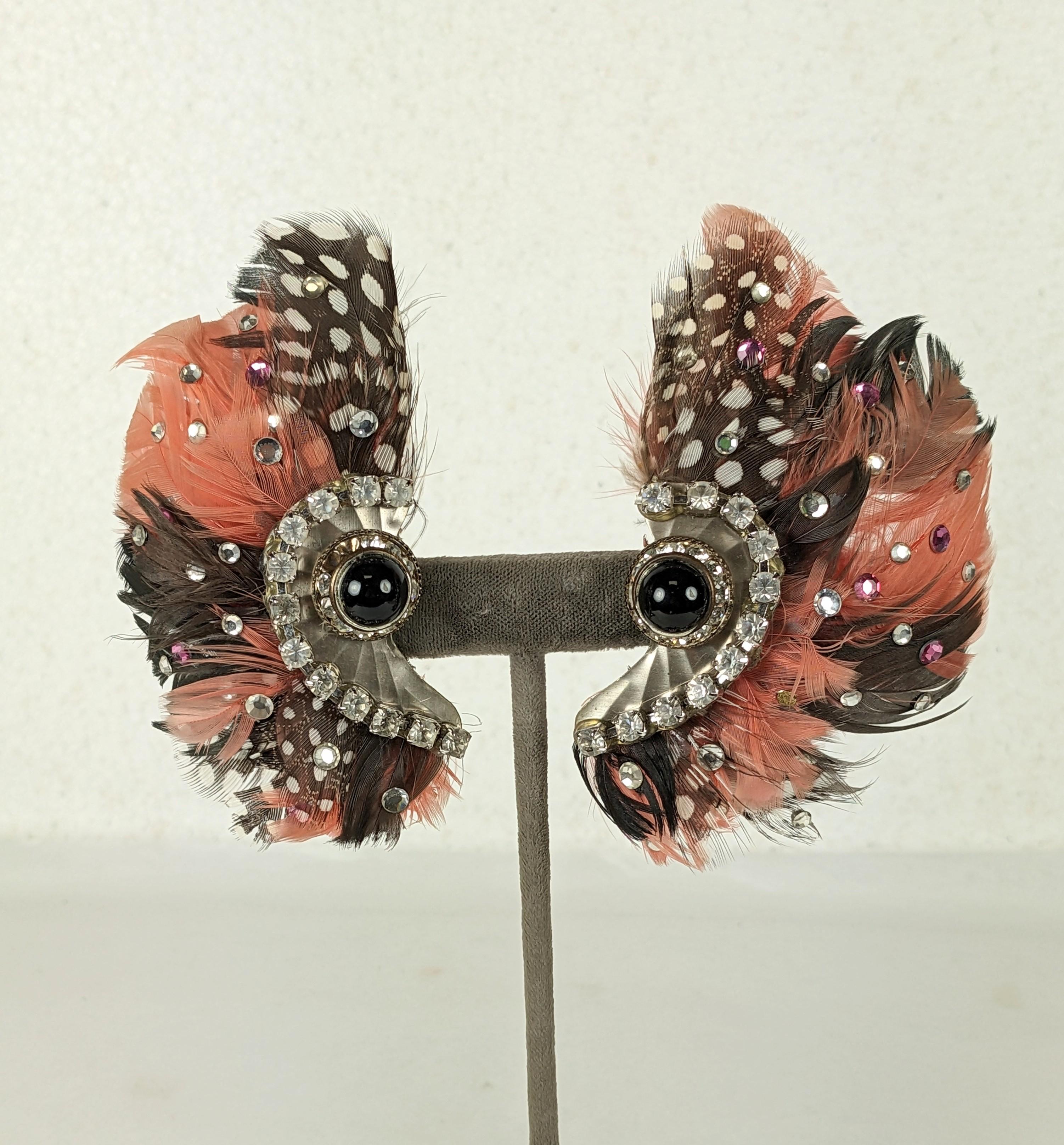 Dramatic Feather and Paste Clip Earrings from the 1980's when the hot glue gun reined supreme. Exotic feathers are hand set with pink and clear crystals with a paste swirl and jet cab. Large and striking scale to accompany outsized hair. 1980's