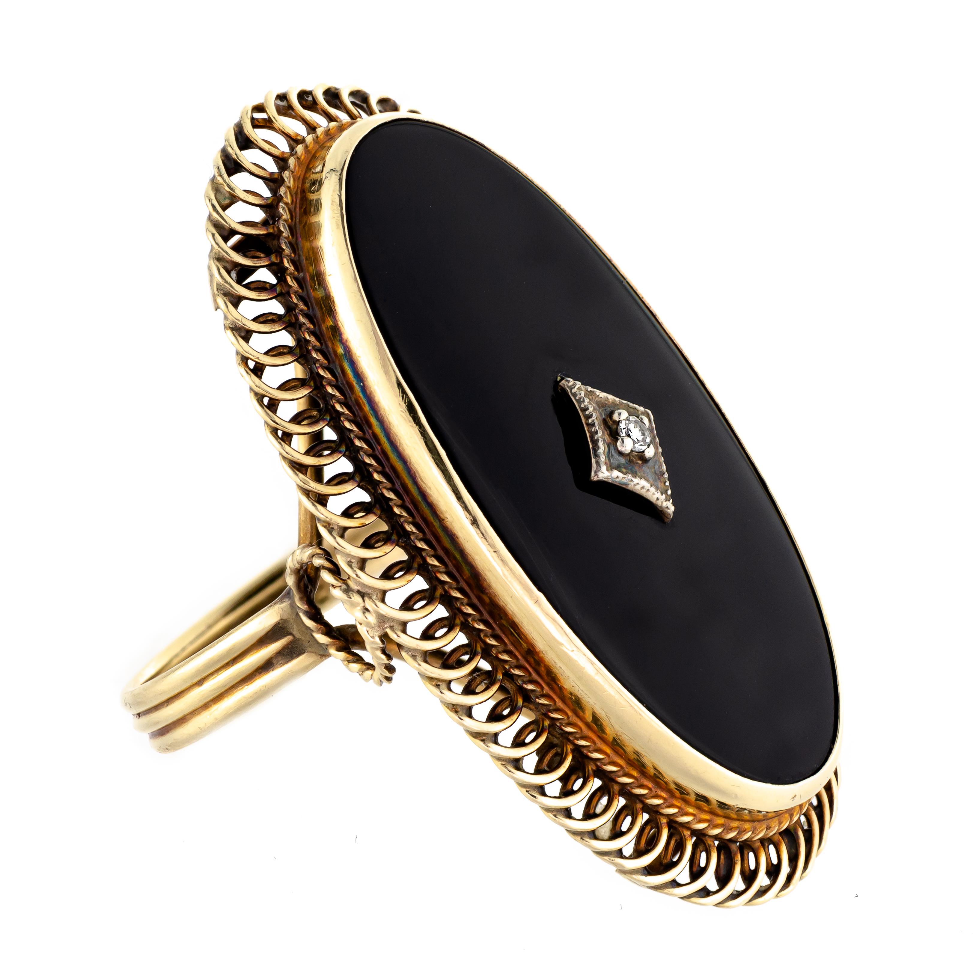 This is a remarkable black onyx diamond ring from the 1930s, crafted from 14kt yellow gold. The ring boasts an impressive size of 1 1/2