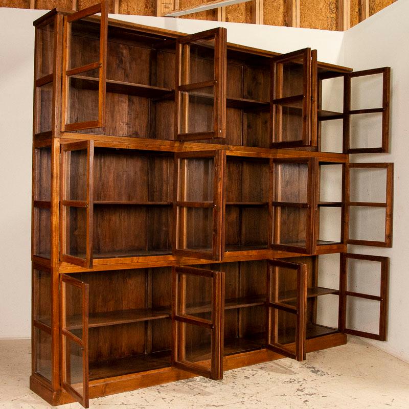 While the lines of this huge elm bookcase are clean and simple, it is dramatic in person due to the incredible size and the many glass panes (including sides) that will show off your library or any collection beautifully. The timeless appeal of this