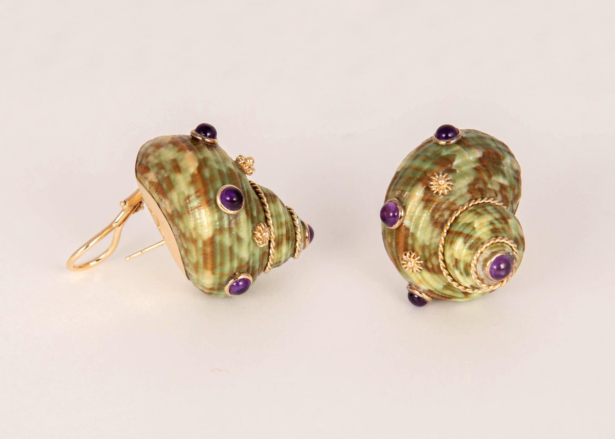 MAZ has selected a pair of uniquely colored shells and decorated them with cabochon amethyst and whimsical gold accents. If you have considered shell earrings but find them generally too large this 7/8's of an inch pair might just be for you. 