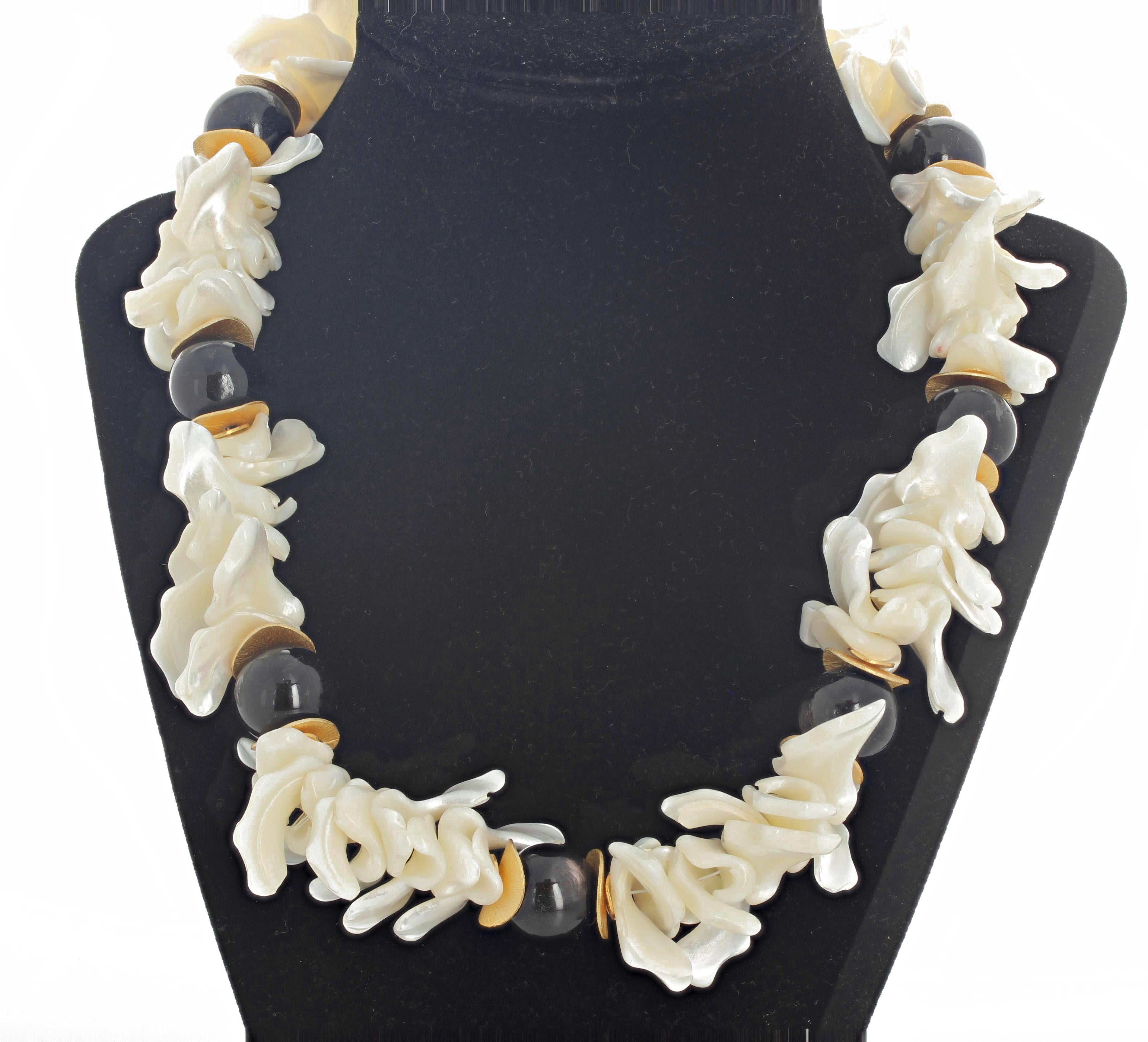Dramatic flakes and petals of white Pearl Shells adorned with large round (15 mm) glowing Chocolate Moonstones enhanced with gold plated rondels set in a 19.5 inch long handmade necklace with gold tone clasp.  The edges of the shells are