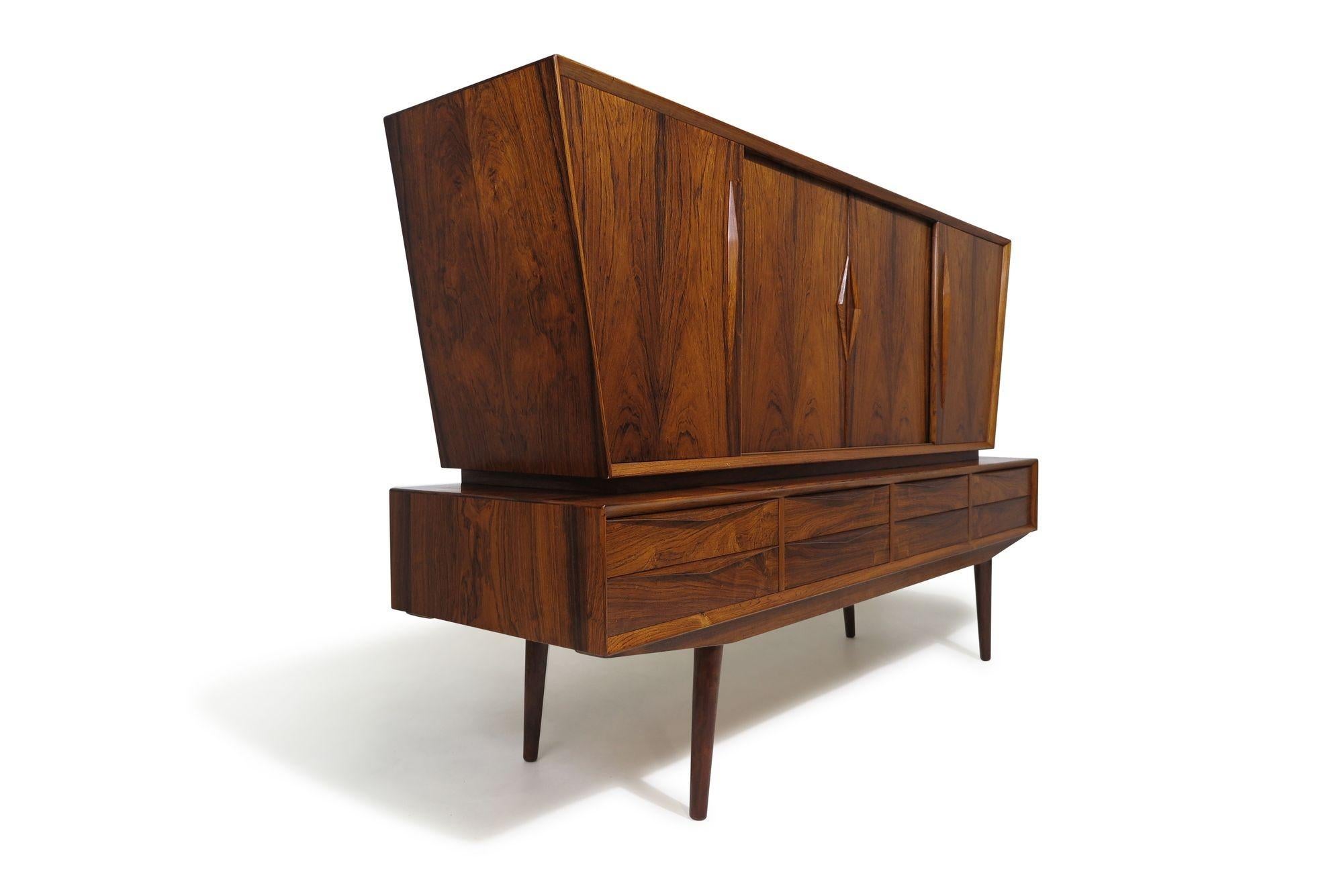 An exceptional Scandinavian cabinet handcrafted from dynamic Brazilian rosewood, featuring an eye-catching design with an angled top over a lower section with drawers. Showcasing fine Danish craftsmanship with meticulously mitered corners and