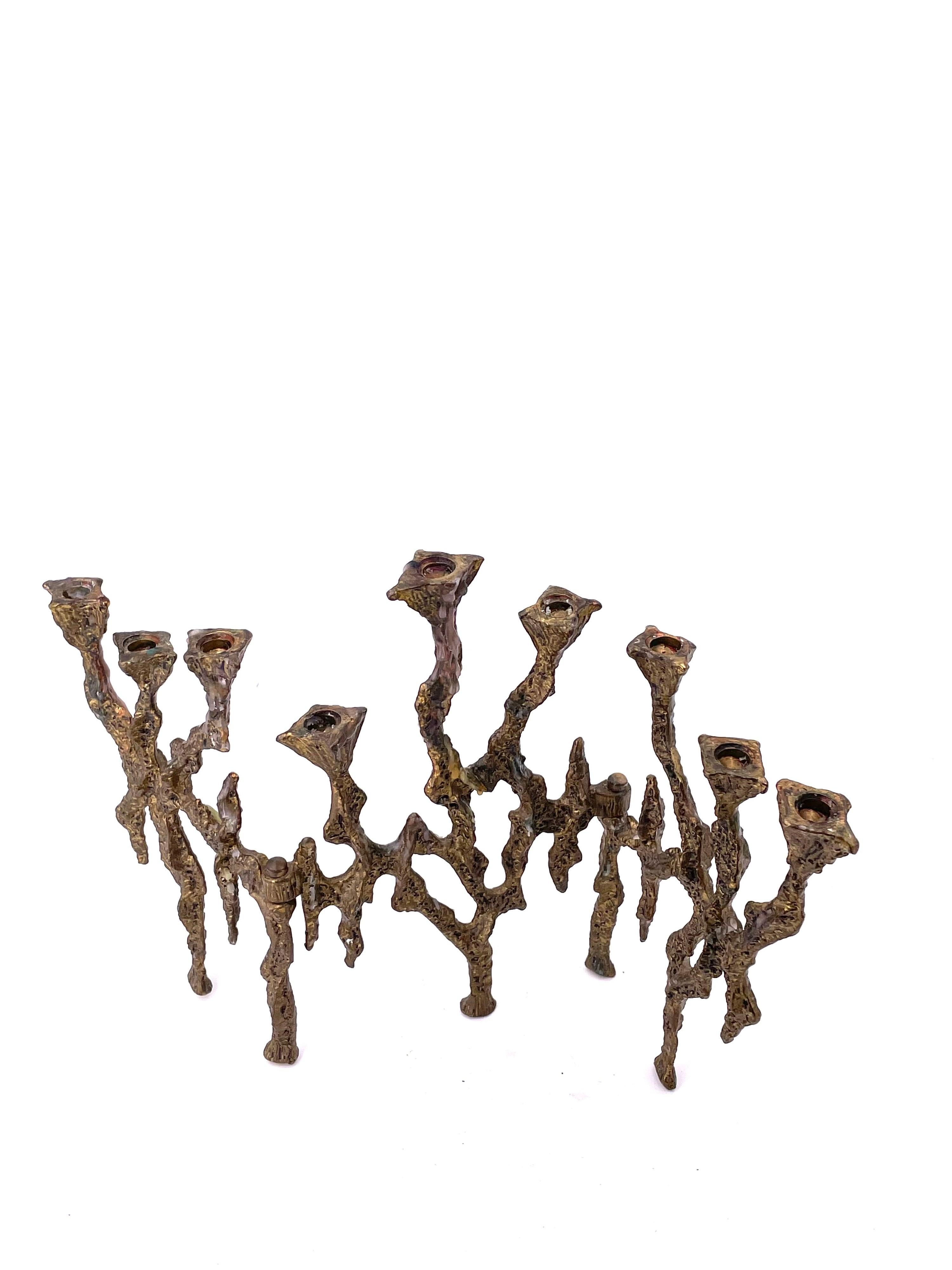 Rare and Brutalist pattern menorah with beaded texture to brass metal, 3 sets of 3 candle cups that are free to rotate at an axis, each cup hole is over 1/4 inch in diameter.

 