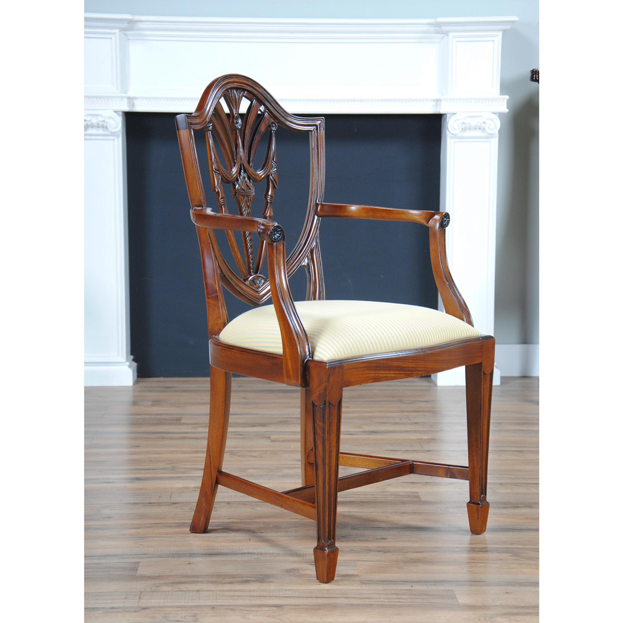 These Drape Carved Shield Back Chairs are sold as a set of 10, featuring two arm chairs and 8 side chairs. This is one of our most popular chair sets. The chairs feature an arched crest rail at the top which itself rests over top a drape carved back