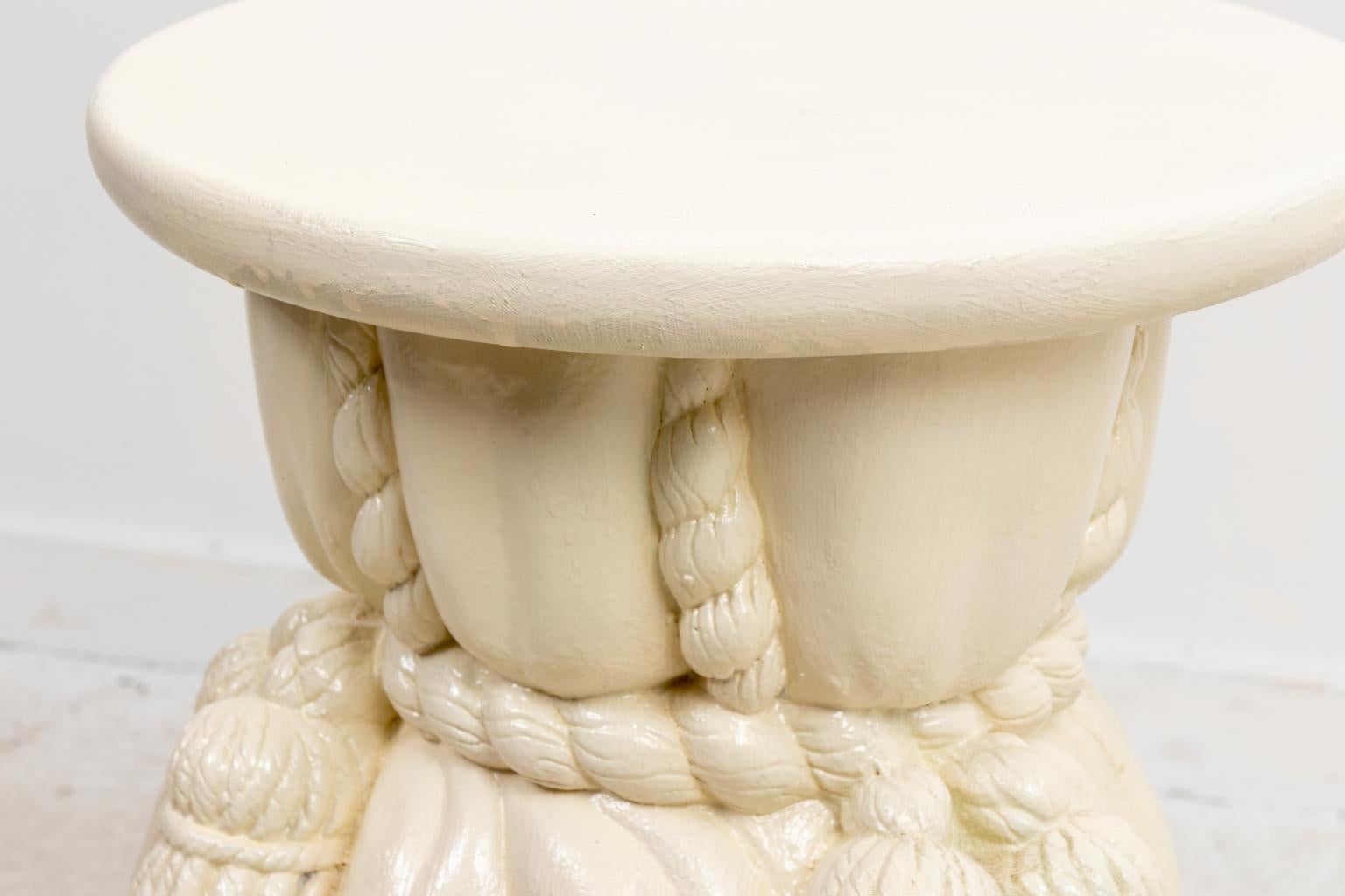 Circa 1990s draped plaster painted stool in the Hollywood Regency style with tassels. Please note of wear consistent with age.