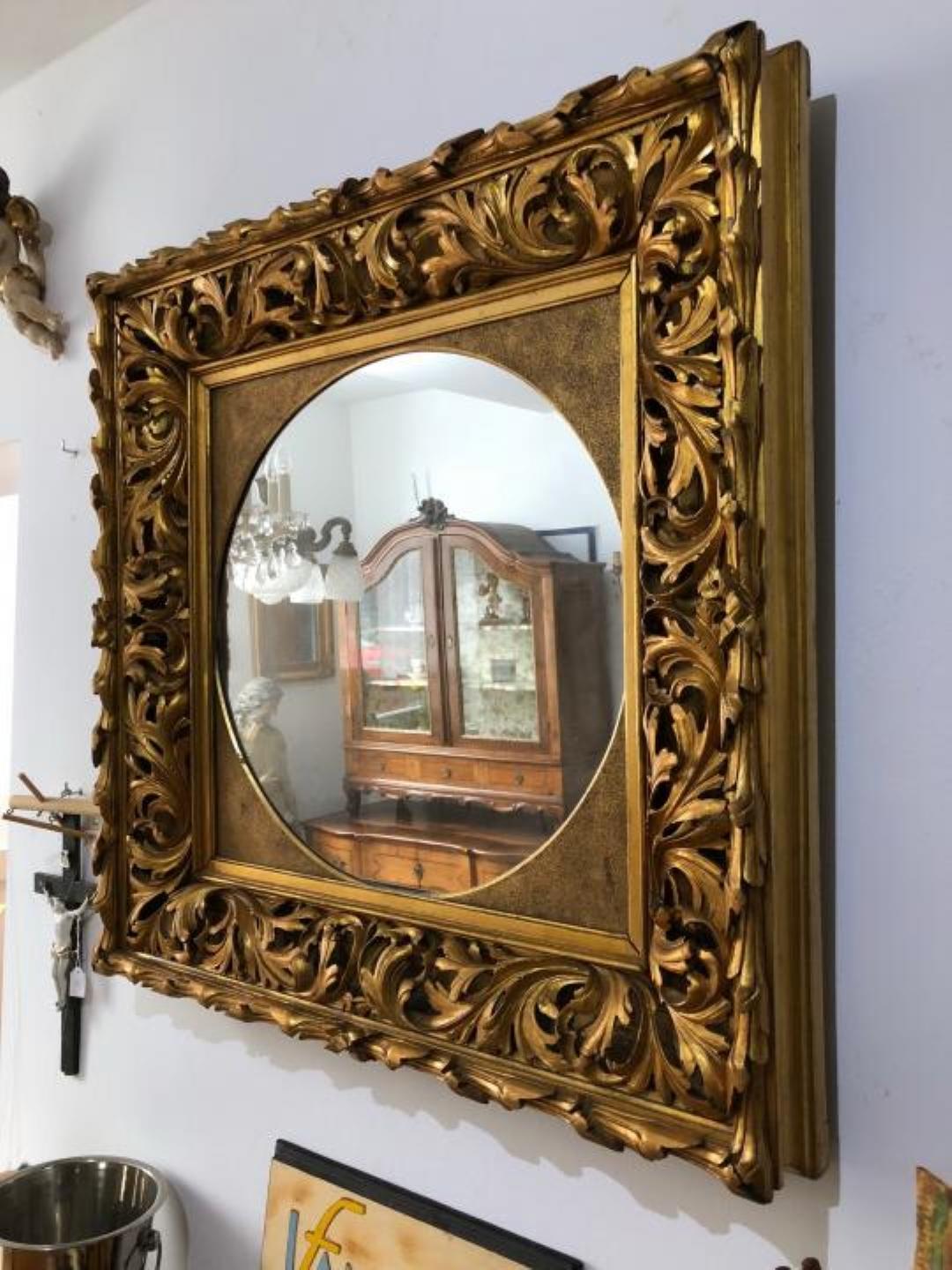 Gilded Florentine wall mirror with acanthus leaf carvings on the frame.
Rare single piece mirror with a square format from Italy.
The frame is in the original gilded condition, this is an original piece
from the period around 1885. It has slight