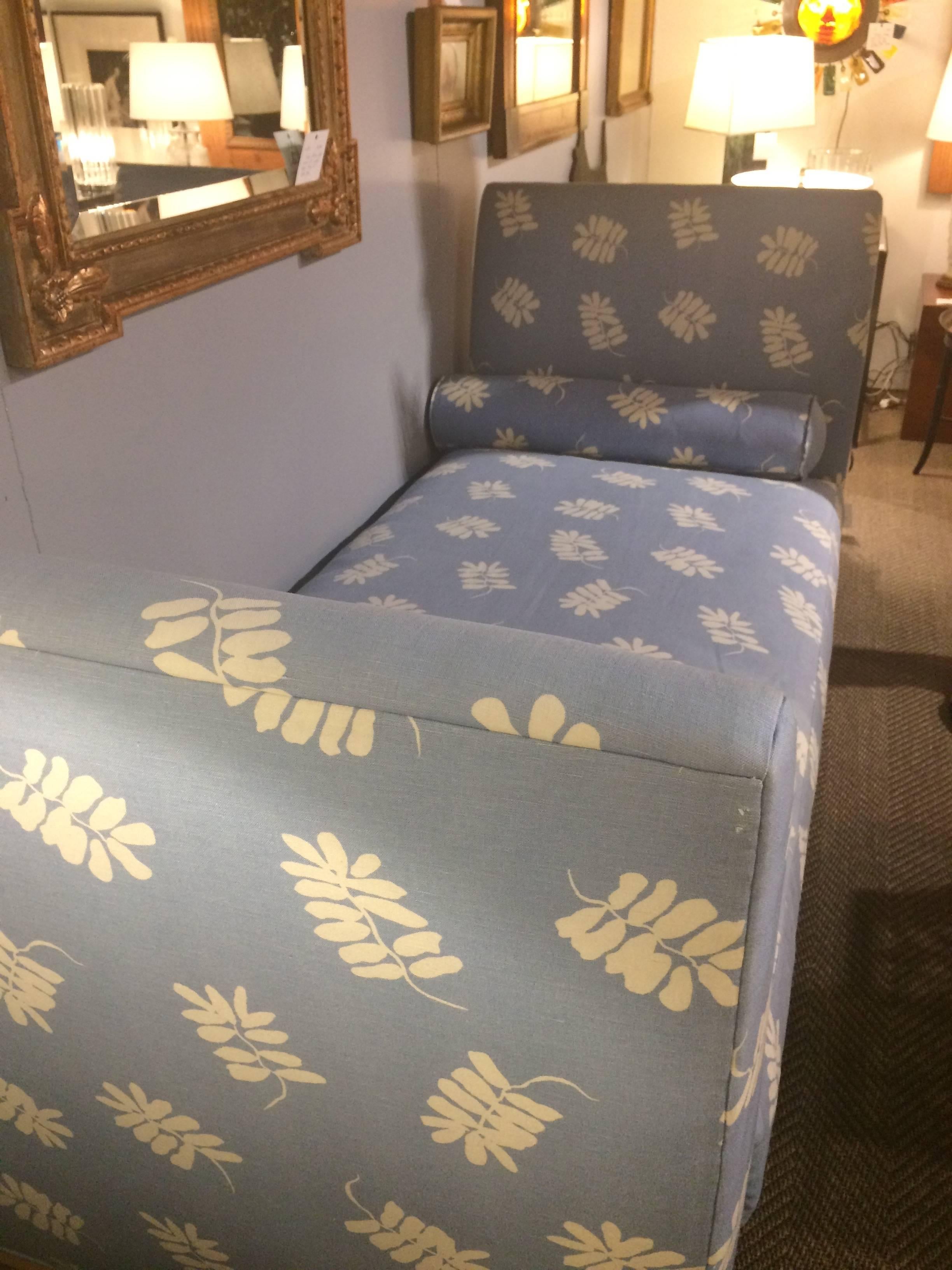 Large comfy daybed upholstered in a light blue and off white leaf motif fabric, having light wood feet, matching bolster pillows, and a super comfy luxurious seat cushion stuffed with down and cotton blend. By Hamilton Furniture.