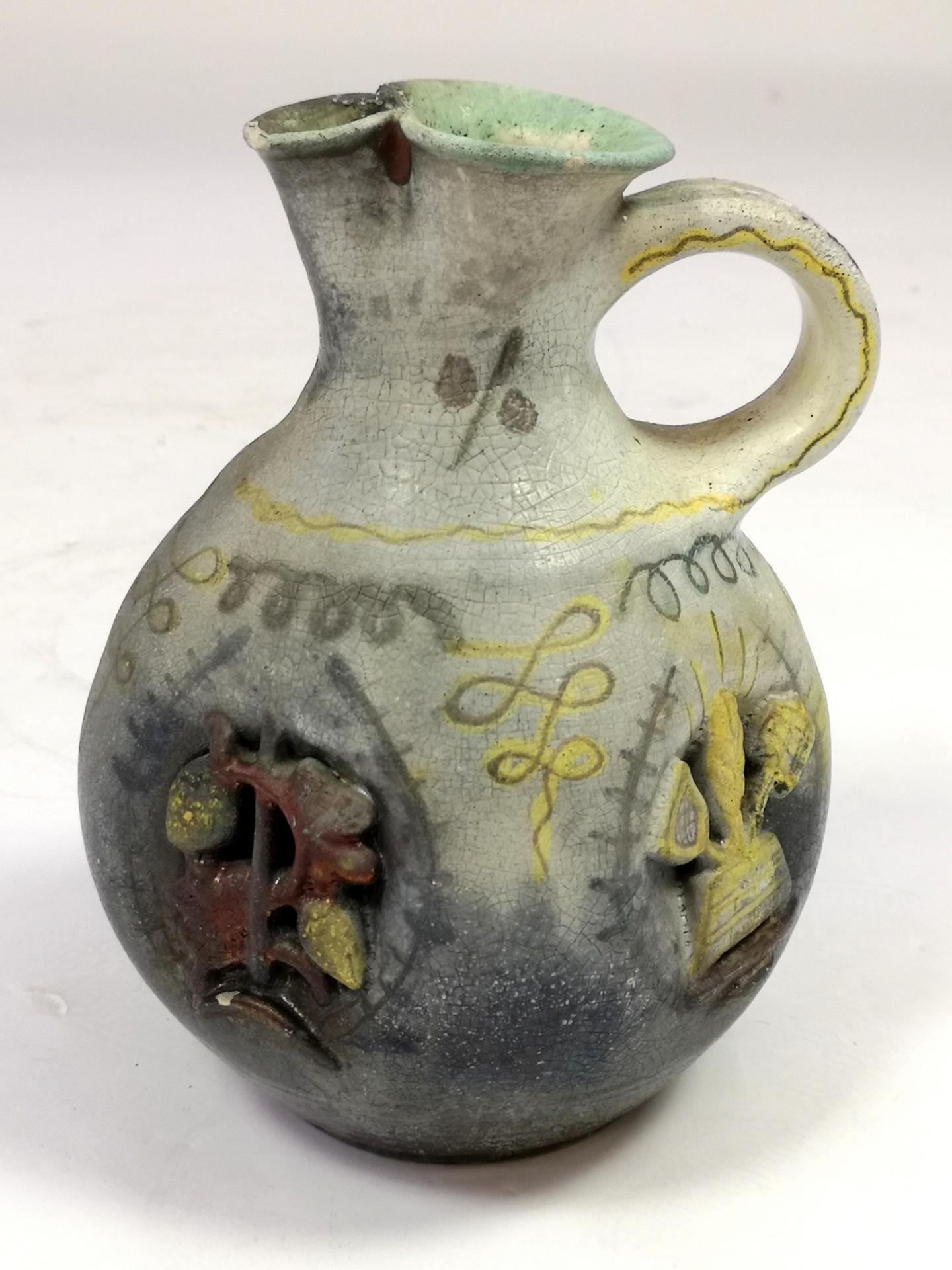 This rare ceramic beer pitcher was made by famous ceramicist Geza Gorka, for Dreher, hungarian beer factory, in the 1930's. It's decorated all around with beer making accessories, malt, barley, keg, etc, and a Hungarian coat of arms. Some chipping
