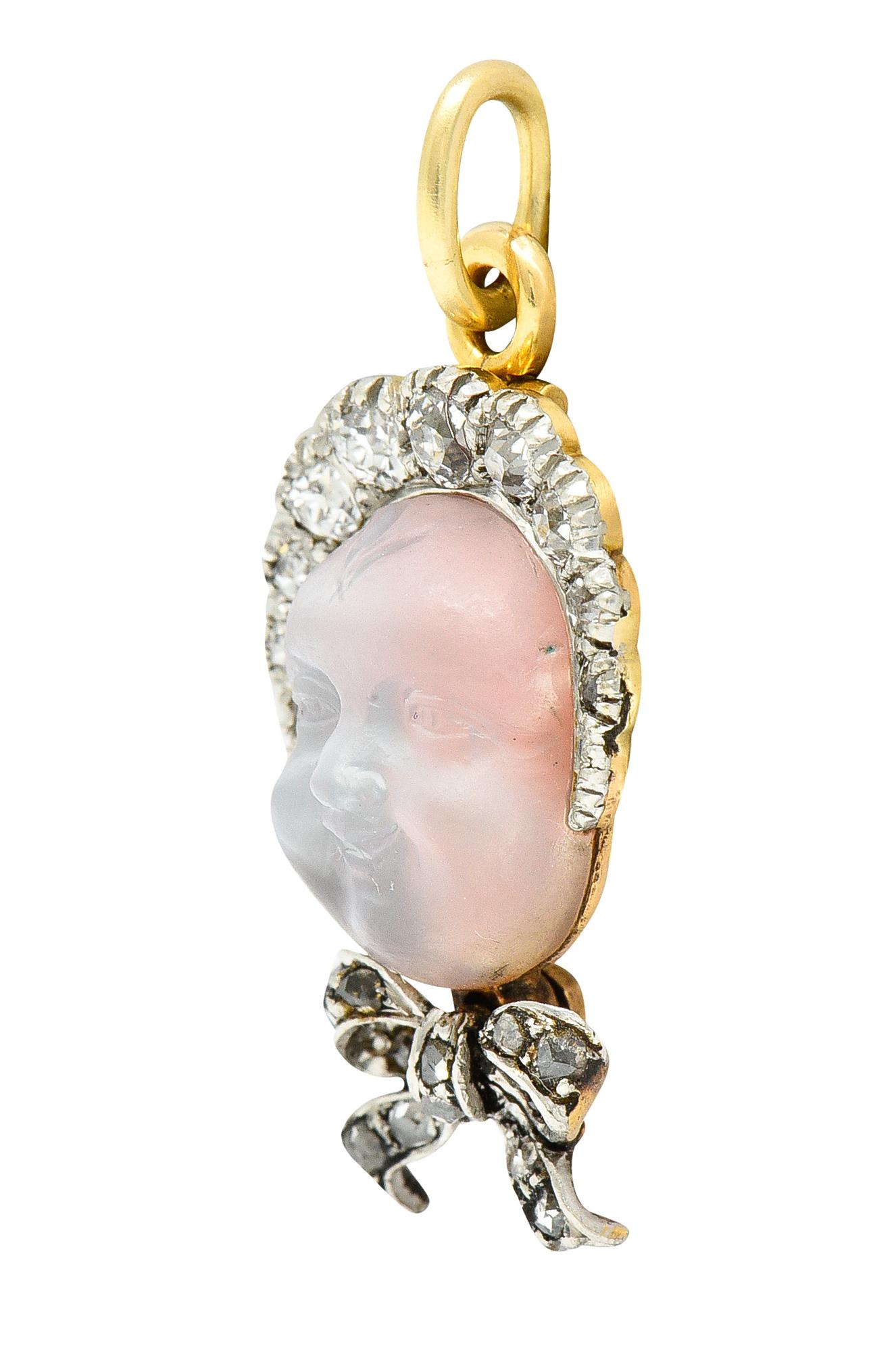 Featuring a carved moonstone cabochon measuring 8.0 x 11.0 mm depicting a baby face. Translucent colorless with white adularescence - wearing a platinum topped bonnet and bow. With old European and rose cut diamonds bead set throughout. Weighing