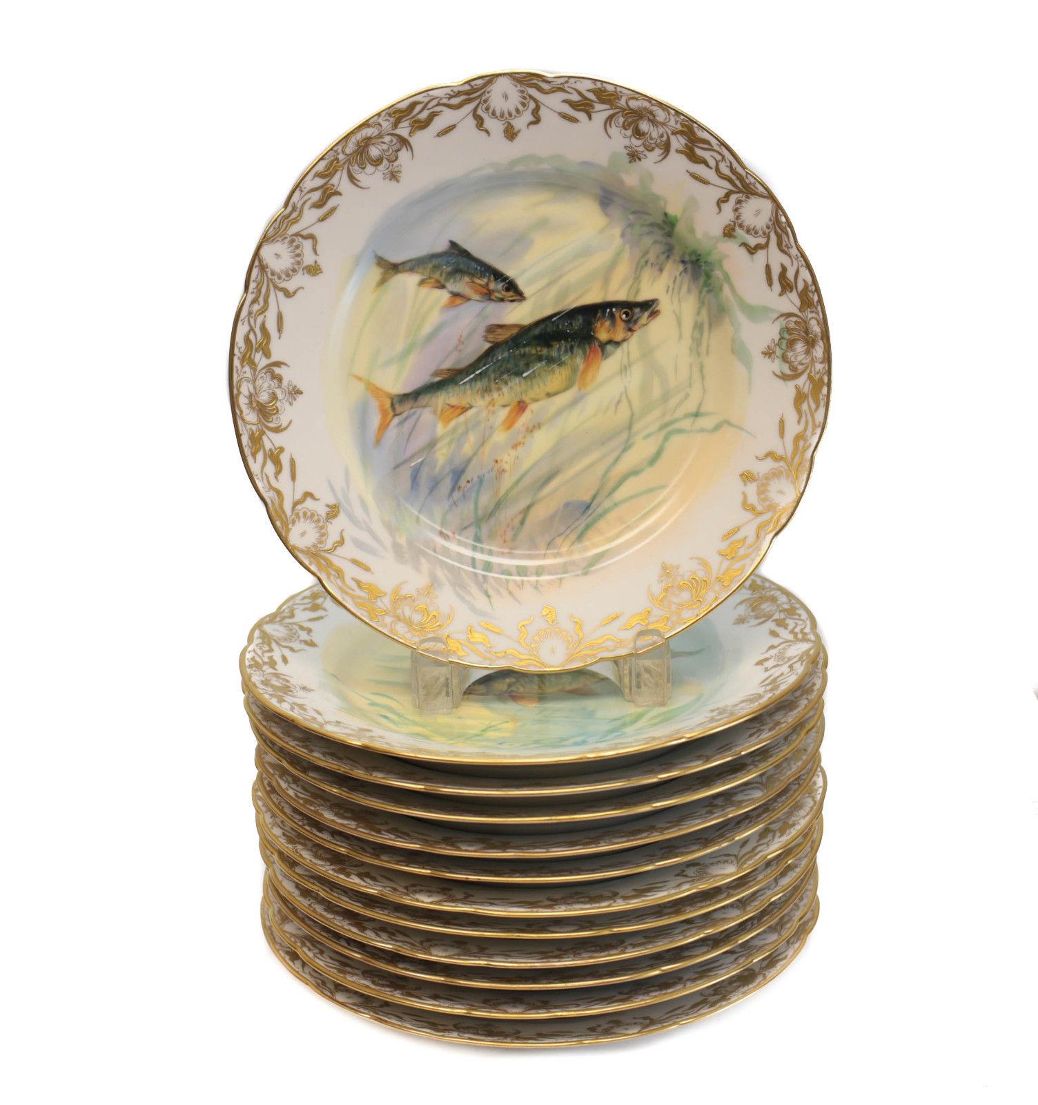 Dresden Ambrosius Lamm hand painted porcelain fish service for 12. Various hand painted fish to the center of the plates and to the fish tray. Gilt seaweed designs to the rim of the plates. Dresden Ambrosius Lamm marks to the underside base. Weight