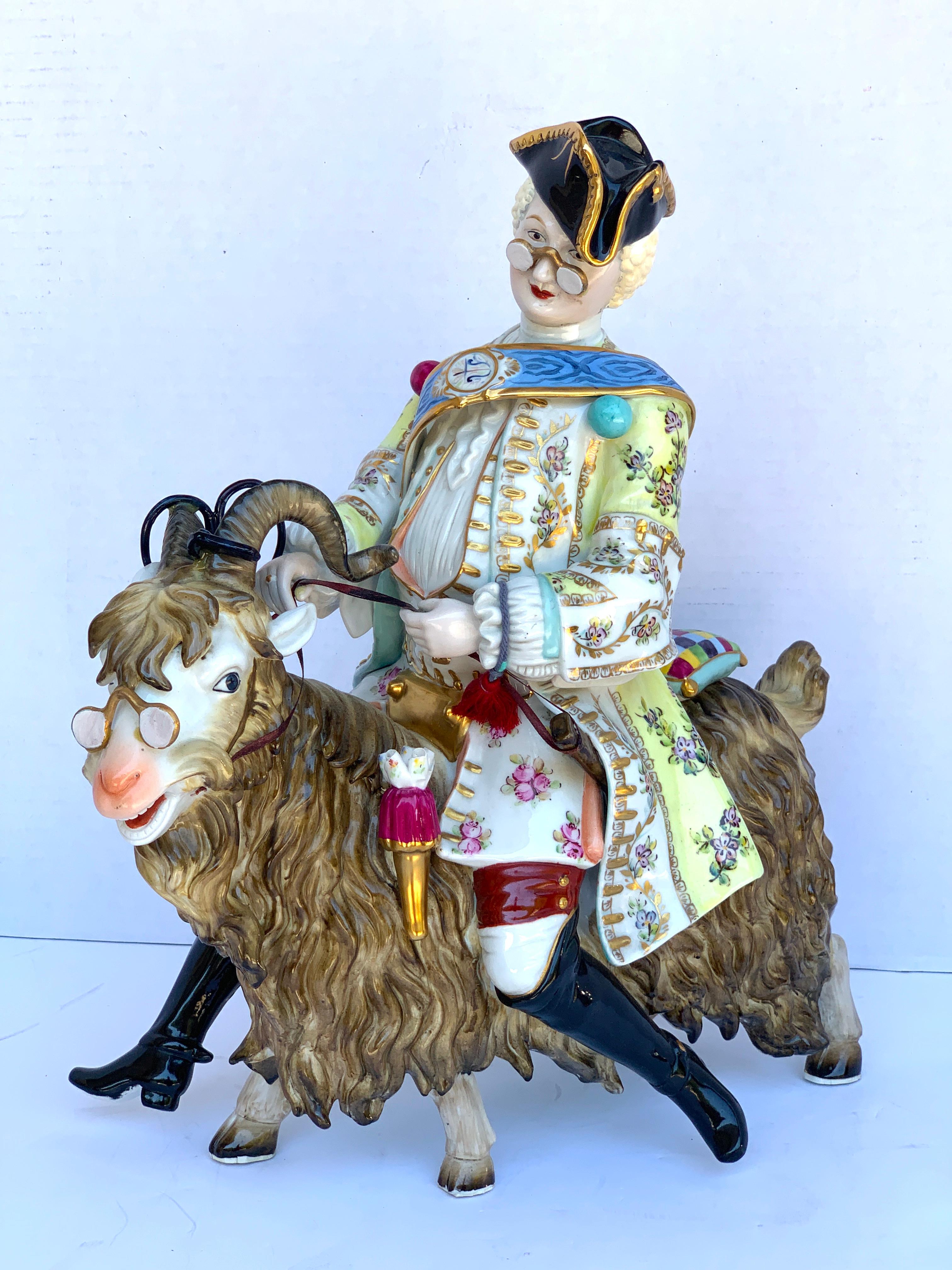 Dresden figure of Count Bruhl's Tailor Astride a Goat and wearing spectacles and tricorn hat.
After the well-known Meissen example designed by J.J. Kändler. 

 