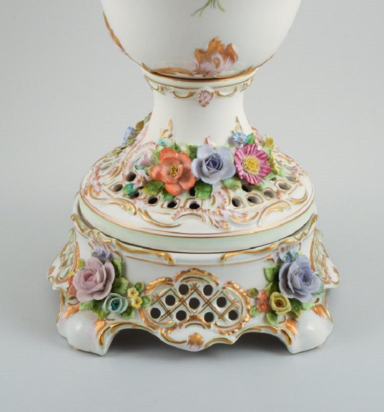 Dresden, Germany. Colossal lidded porcelain vase on stand.
Impressive vase of high quality. In three parts.
Lavishly decorated with flowers in relief, hand-painted.
1920/30s.
Measures 