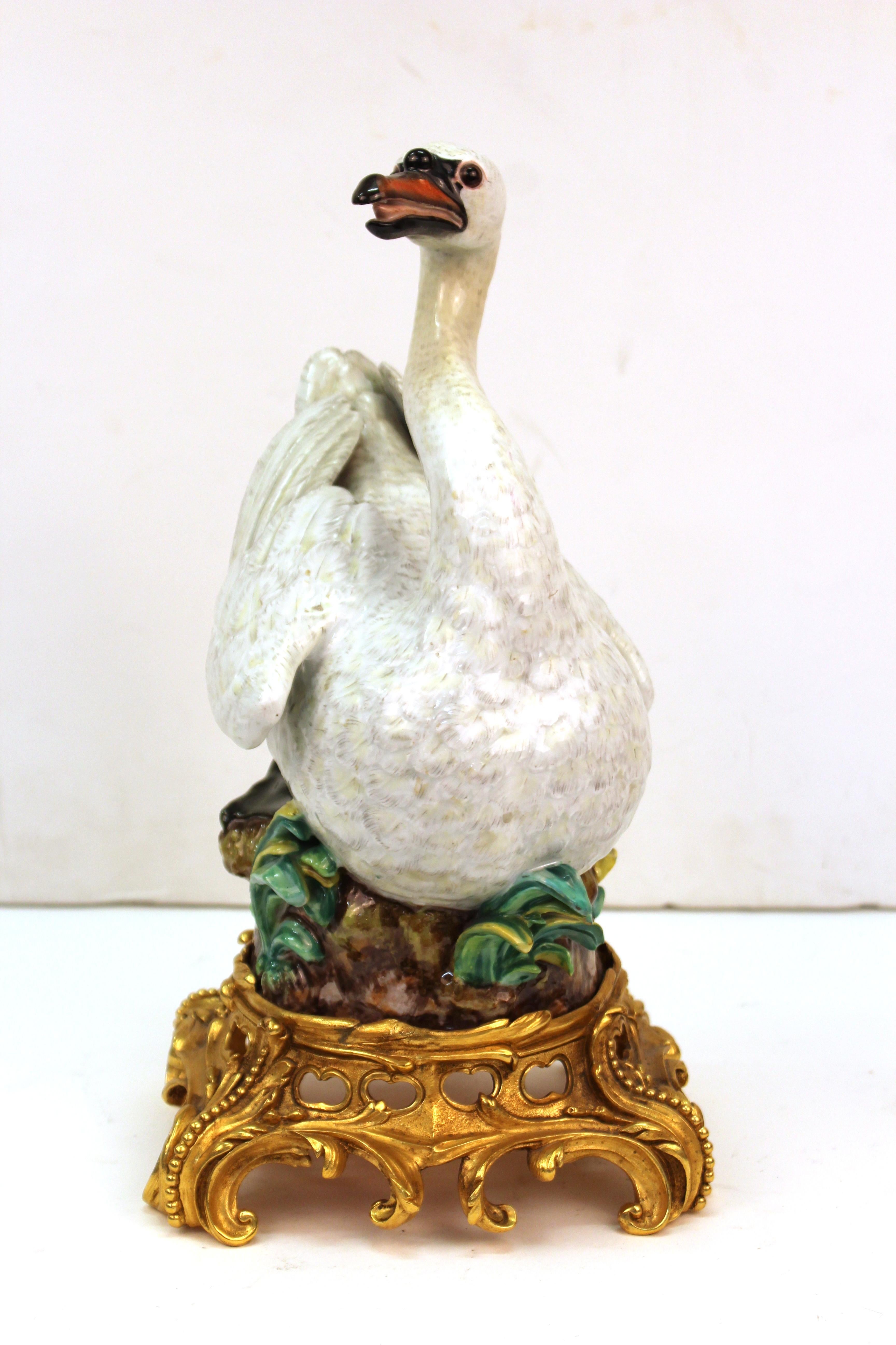 Baroque style porcelain swan sculpture hand-made and hand-painted by Dresden porcelain. The piece is mounted atop a gilt bronze Baroque style base. The swan is hand-painted. In great condition with age-appropriate wear and use and some minor old