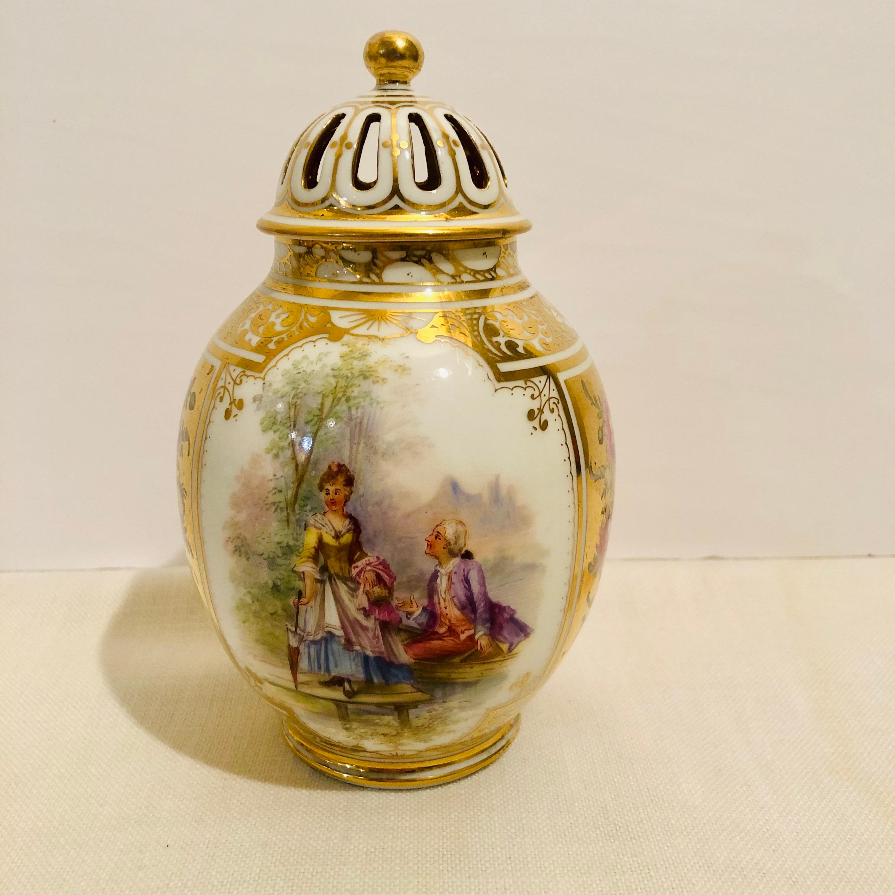 This is a wonderful Dresden potpourri or covered vase, which has two different paintings of lovers on two sides on a white ground and paintings of two different flower bouquets on the other sides with a gold ground. The hand painting is very well