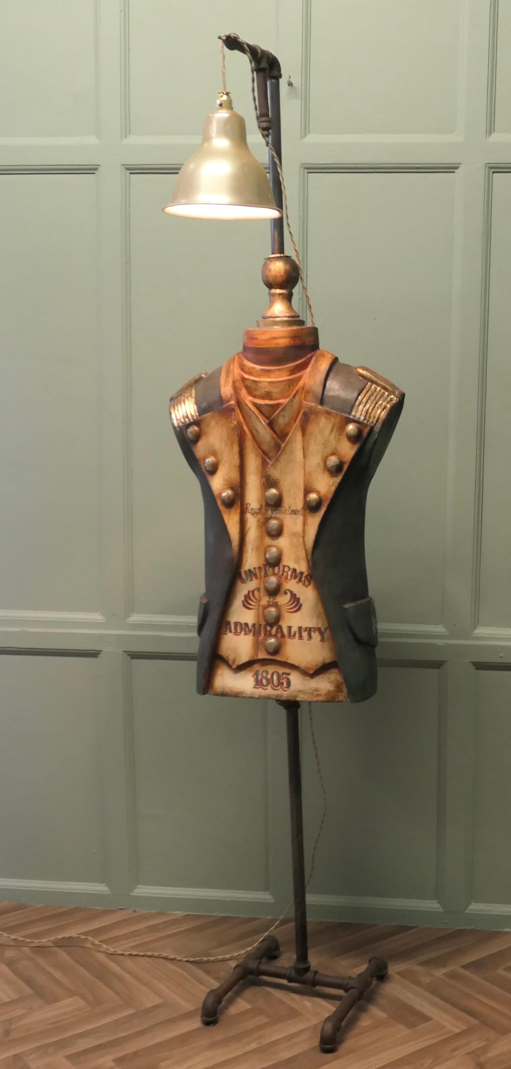 Dressed Navy Sculpture, Floor Lamp

A Fibreglass mannequin in 19th Century dressed uniform, set on a pipework frame and topped with a hanging brass light, the mannequin is dated 1805 and has Admiralty Uniforms and a Royal Appointment