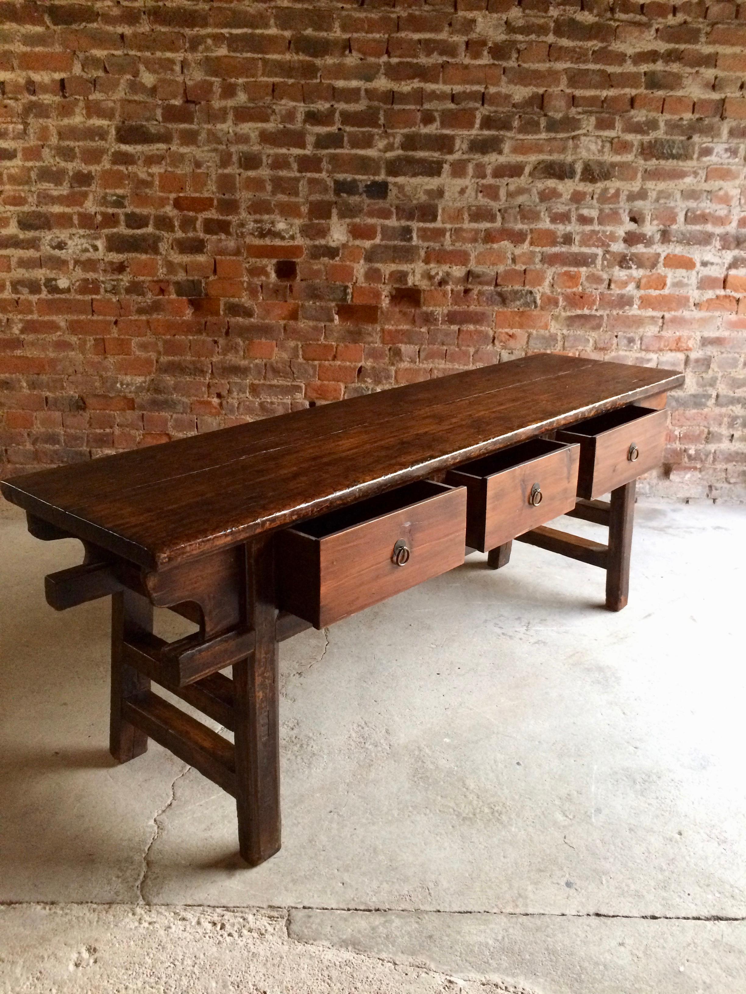 A magnificent antique 'Qing Dynasty' Chinese elm dresser base dating to circa 1850, the beautiful rustic rectangular top over three pull out drawers with original ring pull handles, raised on four square legs with double side stretchers, wonderful