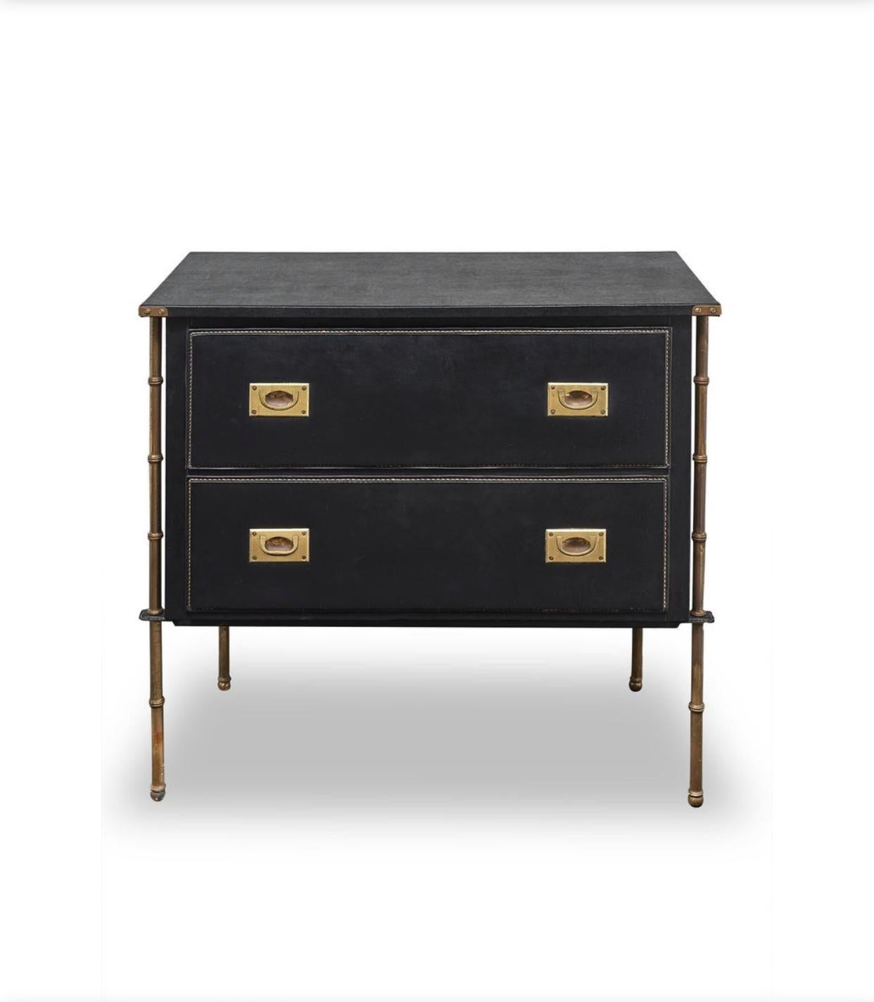Jacques Adnet dresser sheathed in black sewn leather upholstery opening with two drawers resting on a bamboo brass base
from 1950.