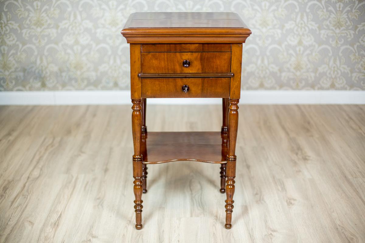 Dresser/Desk/Dressing Table Circa 1860 Veneered With Mahogany

A piece of furniture on turned legs, with a liftable top, and an extended desktop inside.
Under the desktop, there are two drawers, including the one with compartments padded with a