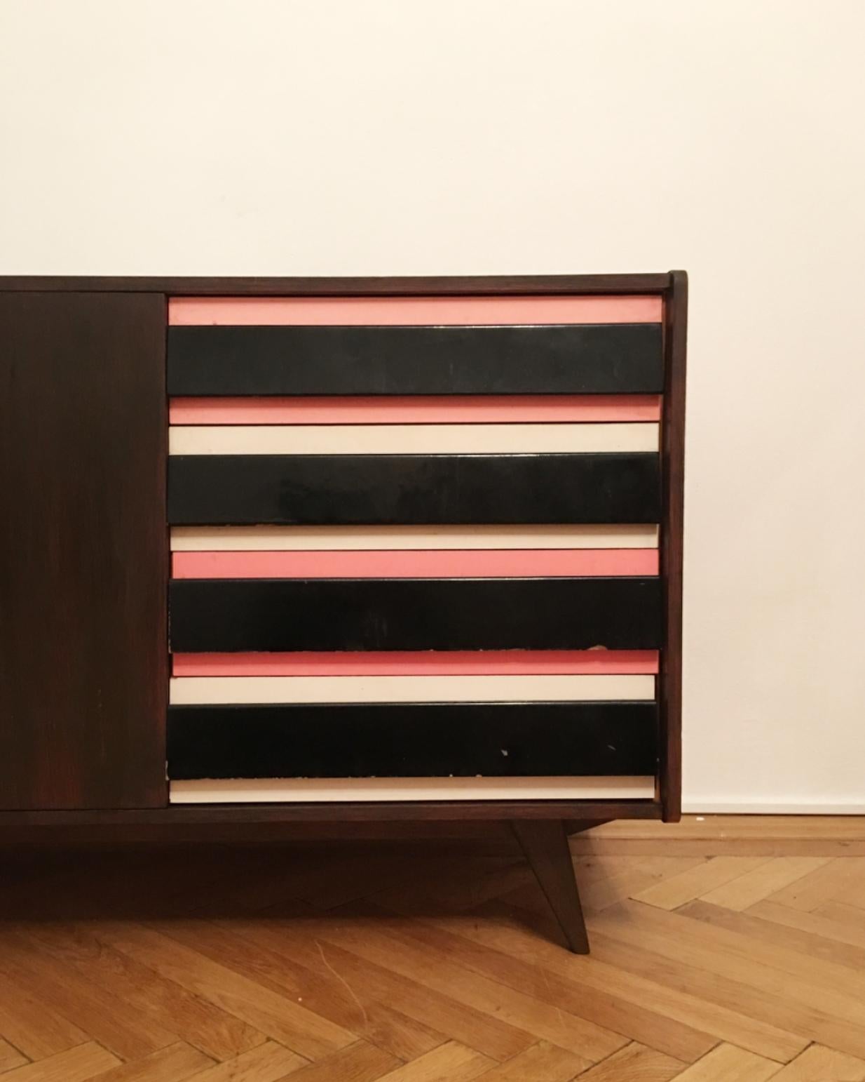 Original vintage sideboard with two doors and the side drawers in black and pink and grey-blue combination. Type U-460, manufactured in the 1960s by Interier Praha, designed by Jiri Jiroutek. Wooden construction and wooden drawers. This piece is