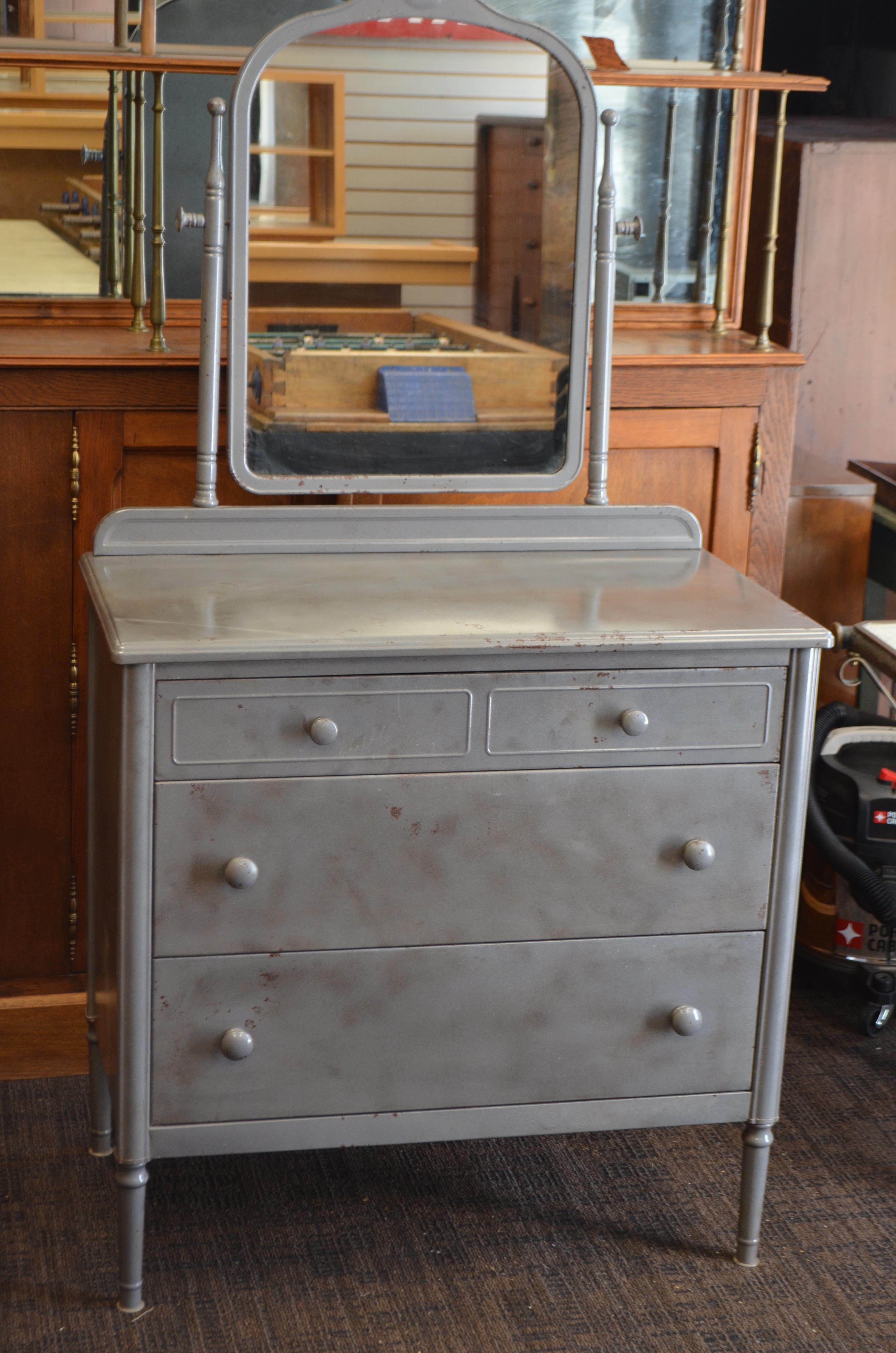 Steel dresser with mirror by Simmons. From a Chicago hotel that opened in the 1930s. Dresser has been refurbished. Drawers slide in and out with ease. Height of dresser to top of the mirror is 64.0 inches.