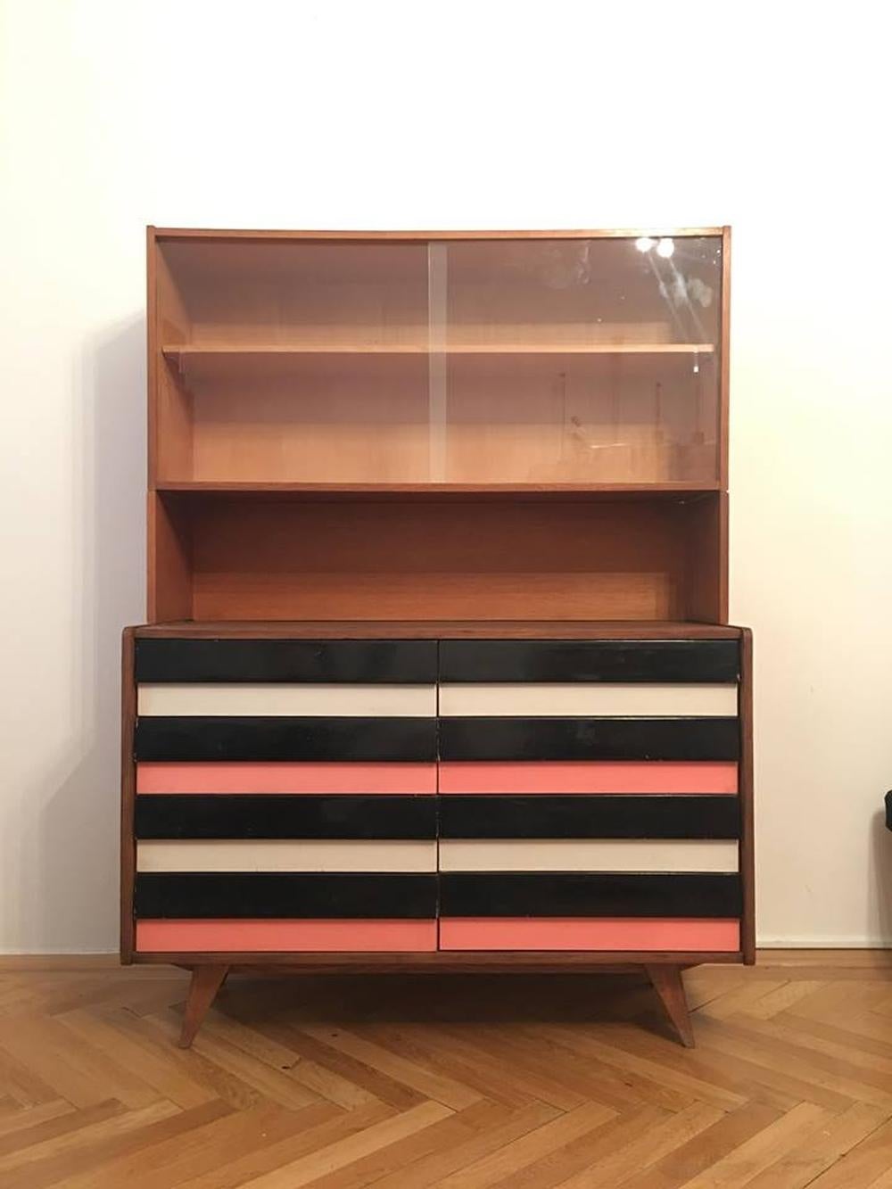 Original vintage chest of drawers with the bookcase. Drawers are in black and pink and grey-blue combination. Type U-453, manufactured in the 1960s by Interier Praha, designed by Jiri Jiroutek. Wooden construction, drawers are made of plastic, the