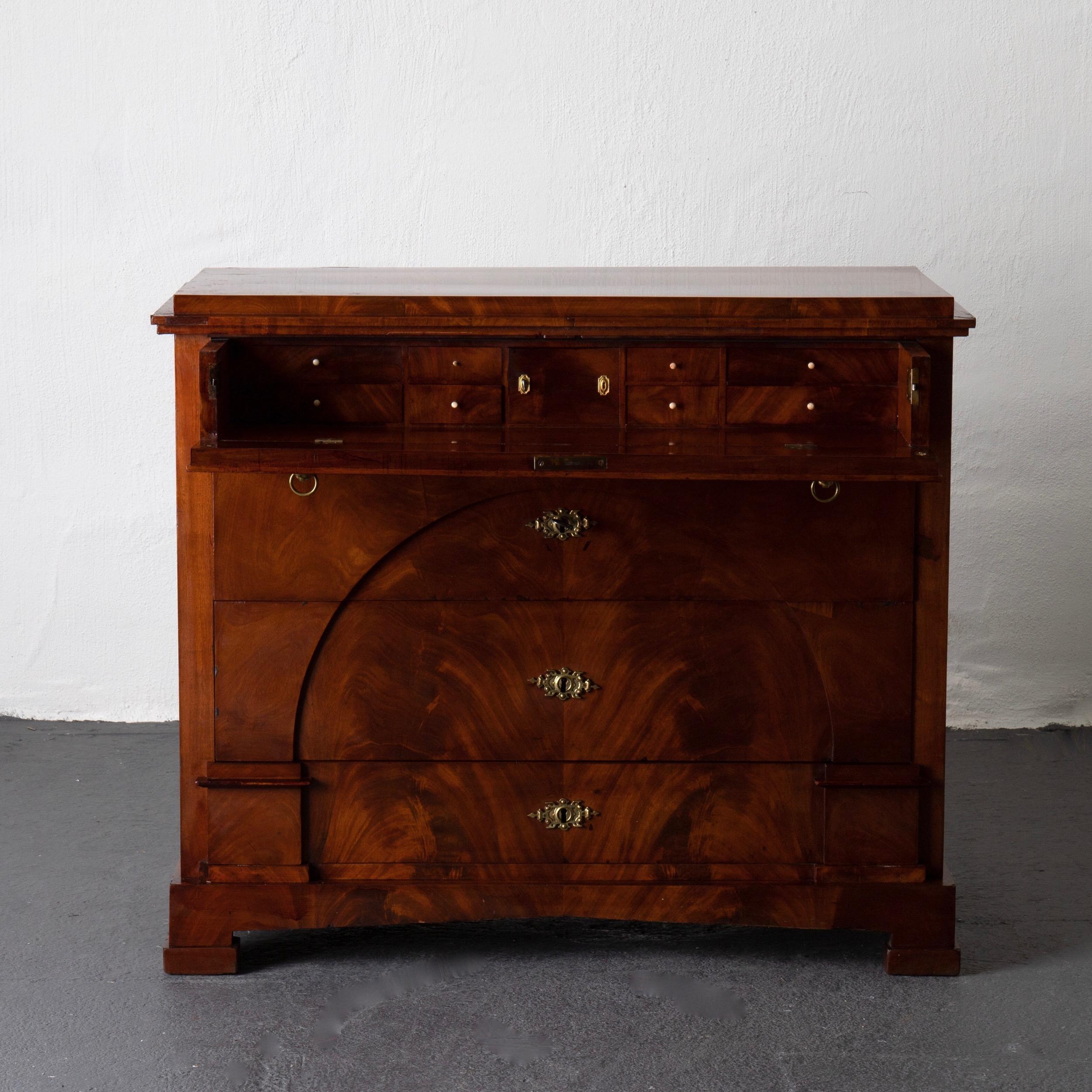 A beautiful chest of drawers made during the Empire period (1810-1830) in Sweden. Signed ABO. Veneered in mahogany decorated with details significant for the period. Brass hardware.

  