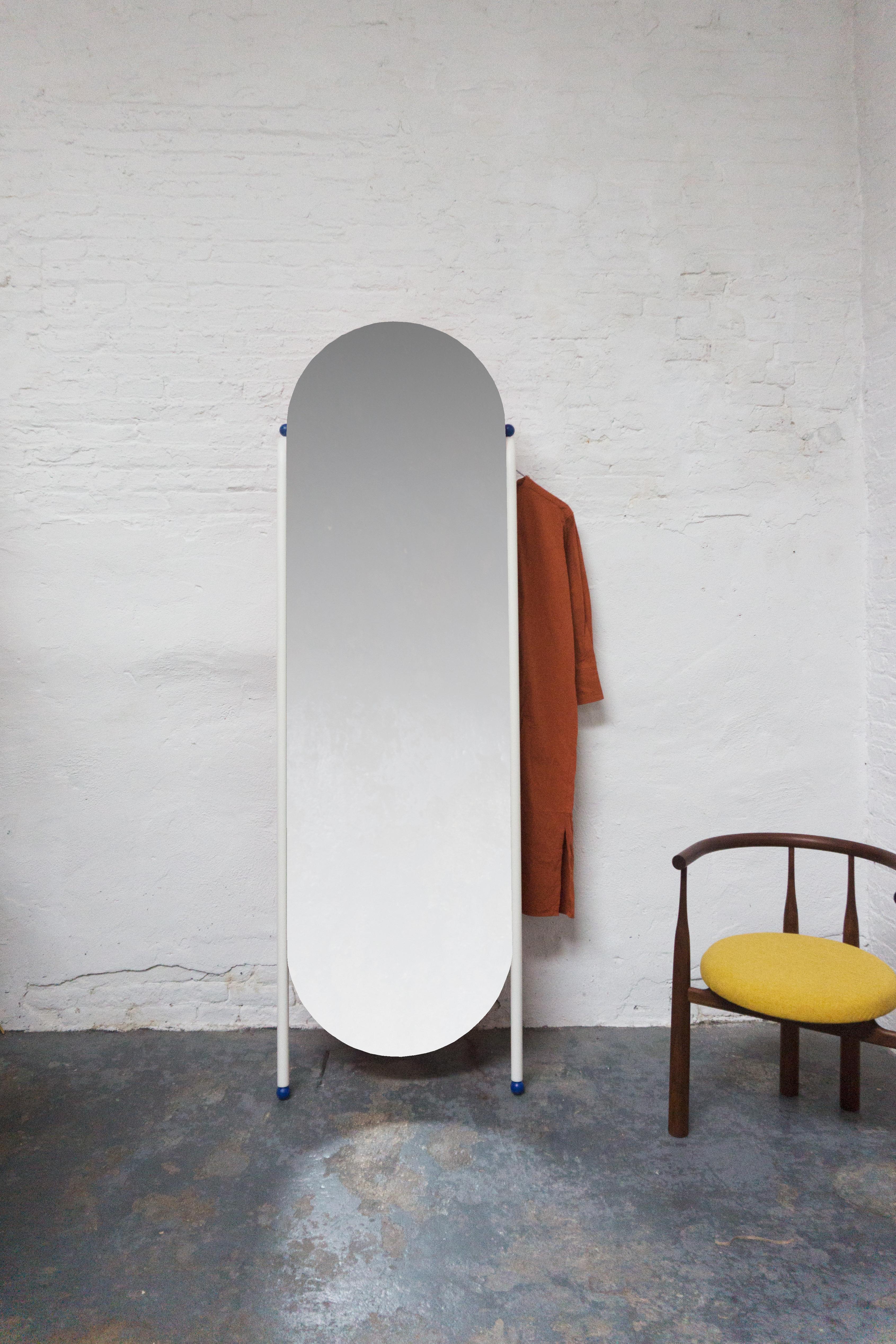 A full length dressing mirror that doubles as a clothing rack to help you keep track of your OOTD. Lacquered steel frame with lacquered wood back and details. 