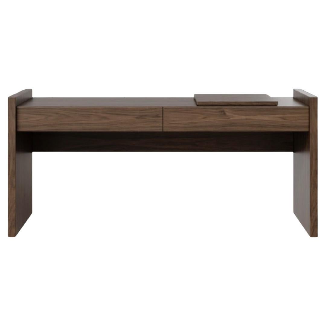 This desk embodies refined simplicity, crafted from premium walnut with a warm, matte finish. Its clean, geometric lines and sleek silhouette make it a versatile addition to modern interiors, blending function with understated elegance. Designed