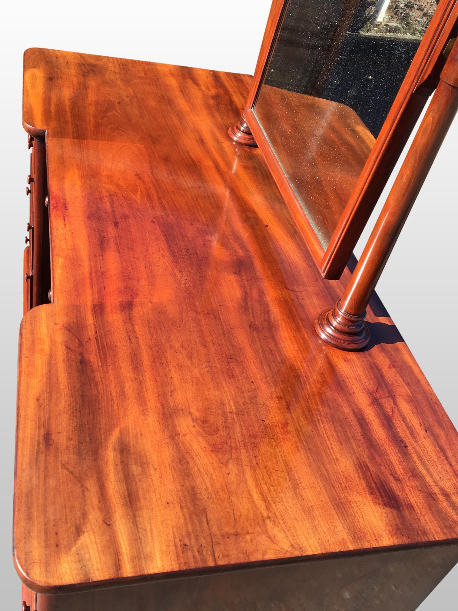 Fine quality antique mahogany dressing table with single mirror and 9 drawers.
The 9 drawers are finely constructed with beautiful veneers, run smoothly
and have their locks and original button handles.
The single mirror is fitted to tapering finial