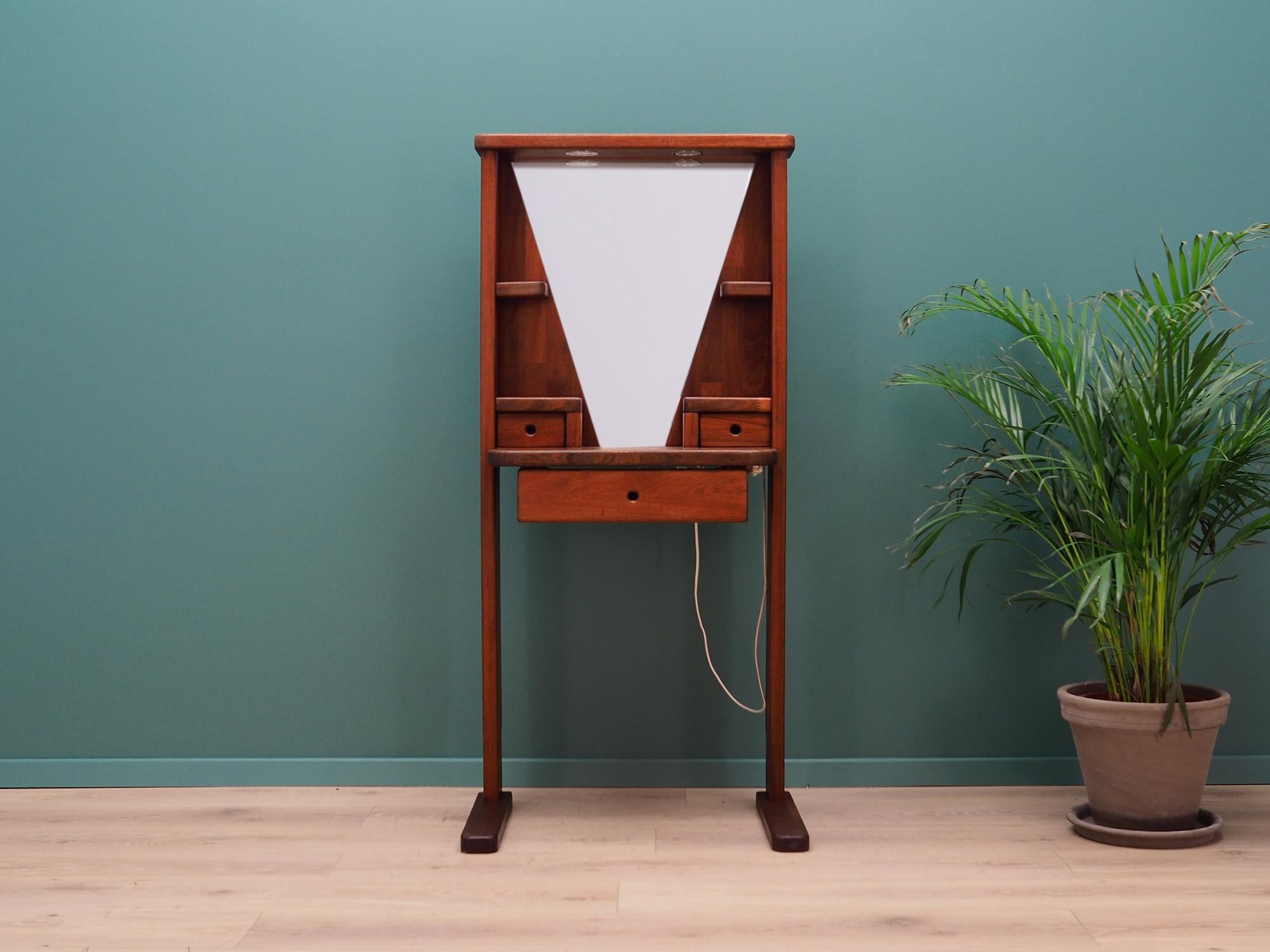 Brilliant Danish dressing table from the 1960s-1970s. Scandinavian design, Minimalist form. Construction made of solid teak wood. Toilet has a mirror with efficient lighting and a practical drawer. Preserved in good condition (small bruises and