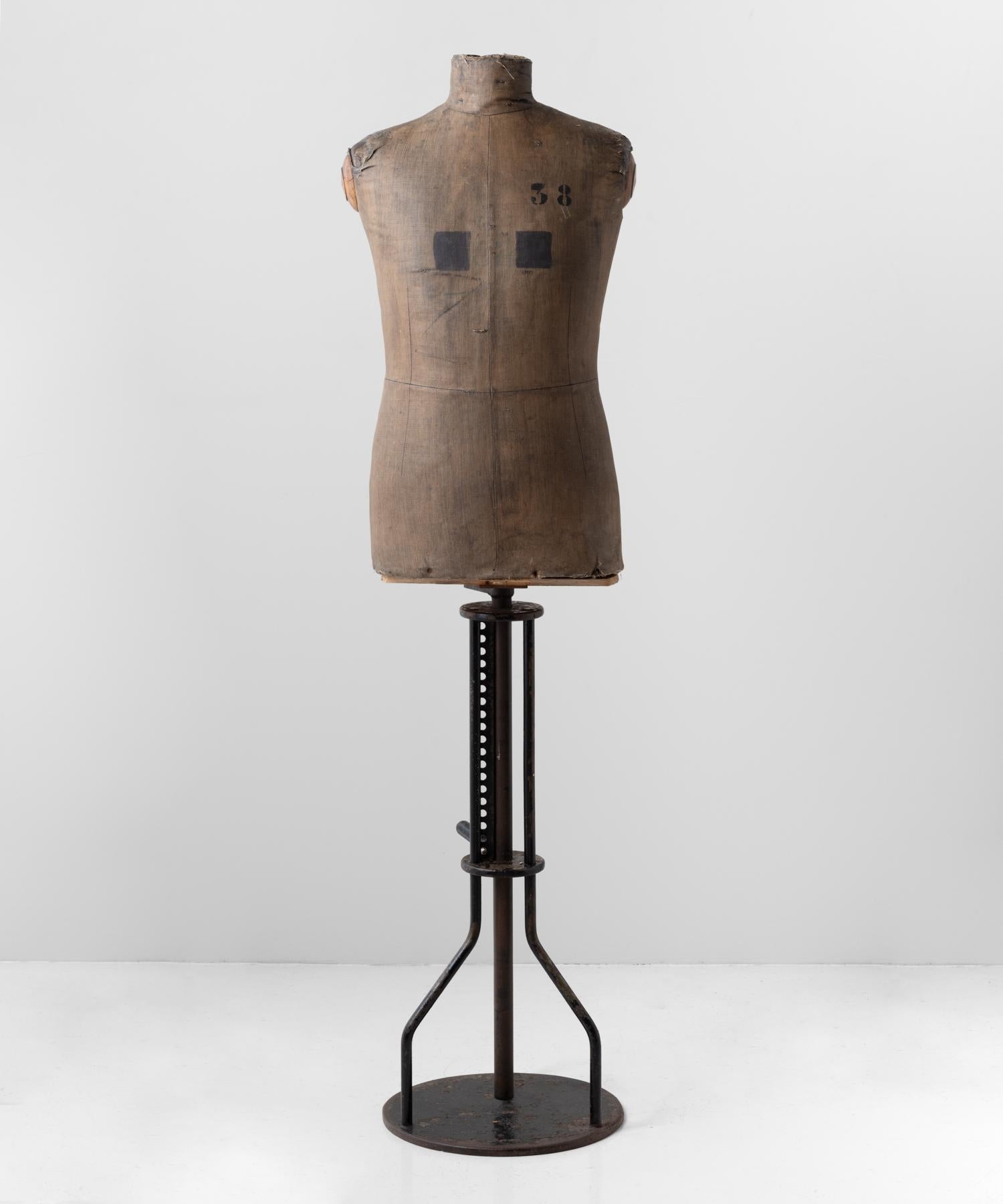 Dressmakers Display Mannequin, Northern European, circa 1920.

Raised on adjustable metal base, with painted metal, carton cache and painted fabric.